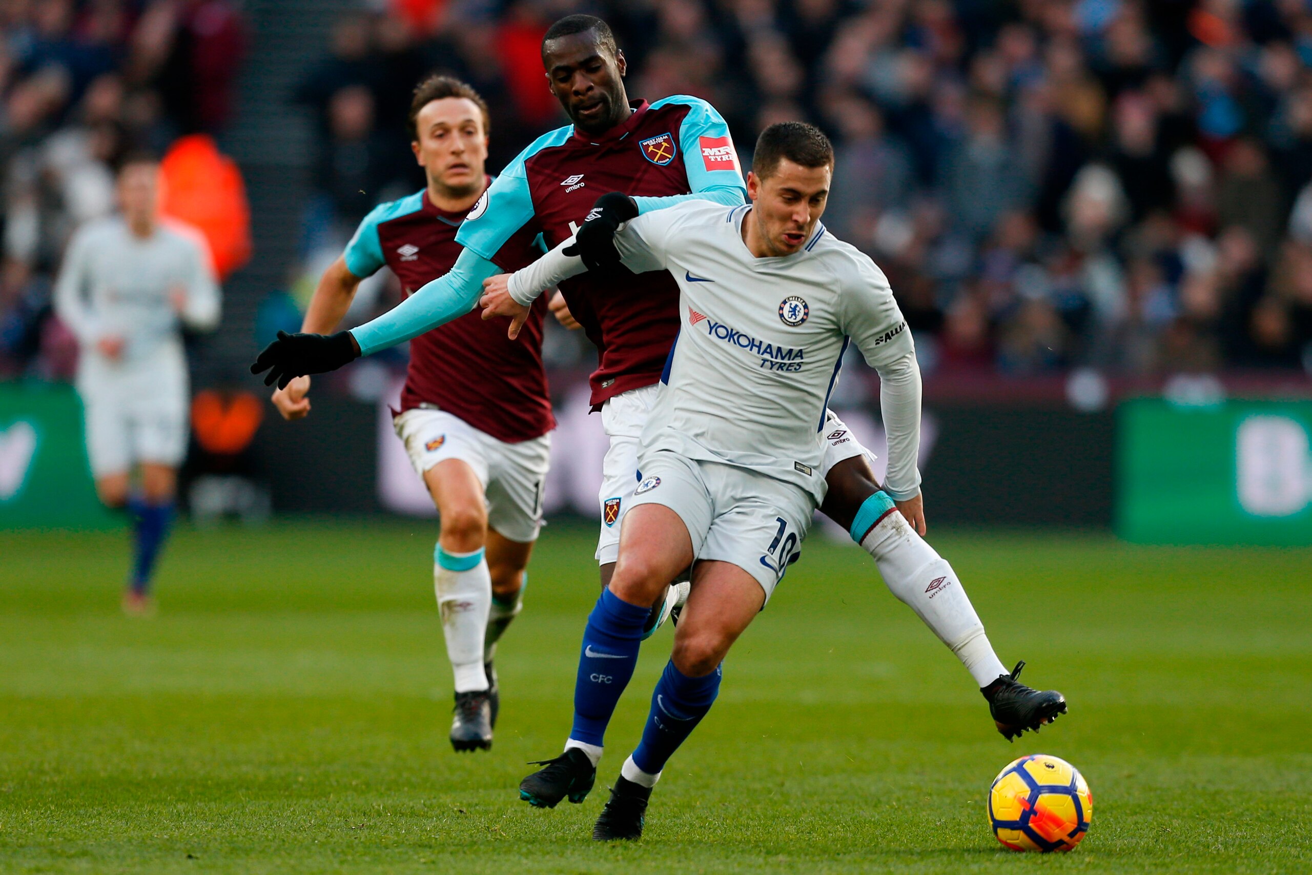 West Ham United's Spanish midfielder Pedro Obiang vies with Chelsea's Belgian midfielder Eden Hazard (R) during the English Premier League football match between West Ham United and Chelsea at The London Stadium, in east London on December 9, 2017. / AFP West Ham United's Spanish midfielder Pedro Obiang vies with Chelsea's Belgian midfielder Eden Hazard (R) during the English Premier League football match between West Ham United and Chelsea at The London Stadium, in east London on December 9, 2017. / AFP