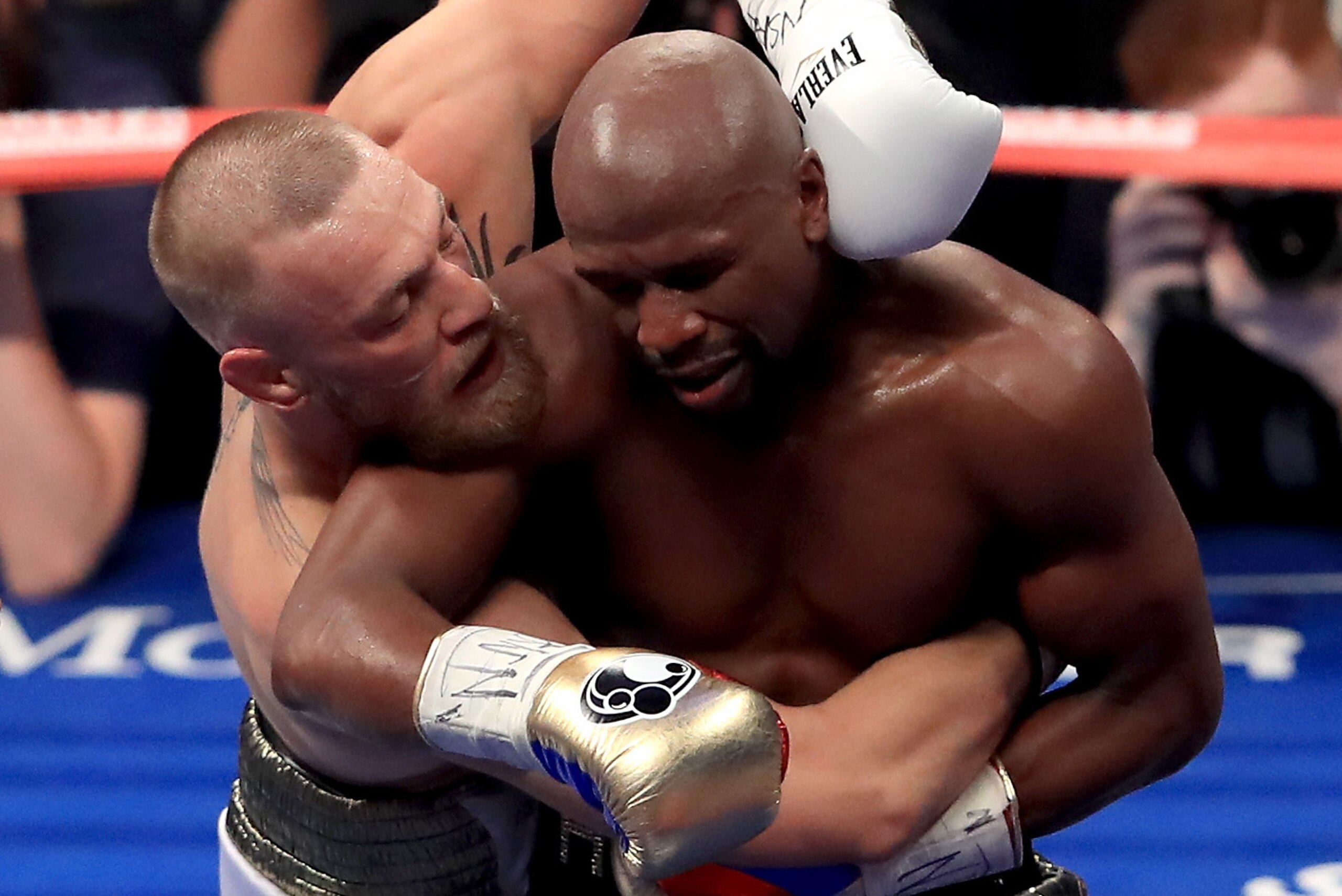 LAS VEGAS, NV - AUGUST 26:  (R-L) Floyd Mayweather Jr. and Conor McGregor hold during their super welterweight boxing match on August 26, 2017 at T-Mobile Arena in Las Vegas, Nevada.  (Photo by Sean M. Haffey/Getty Images)