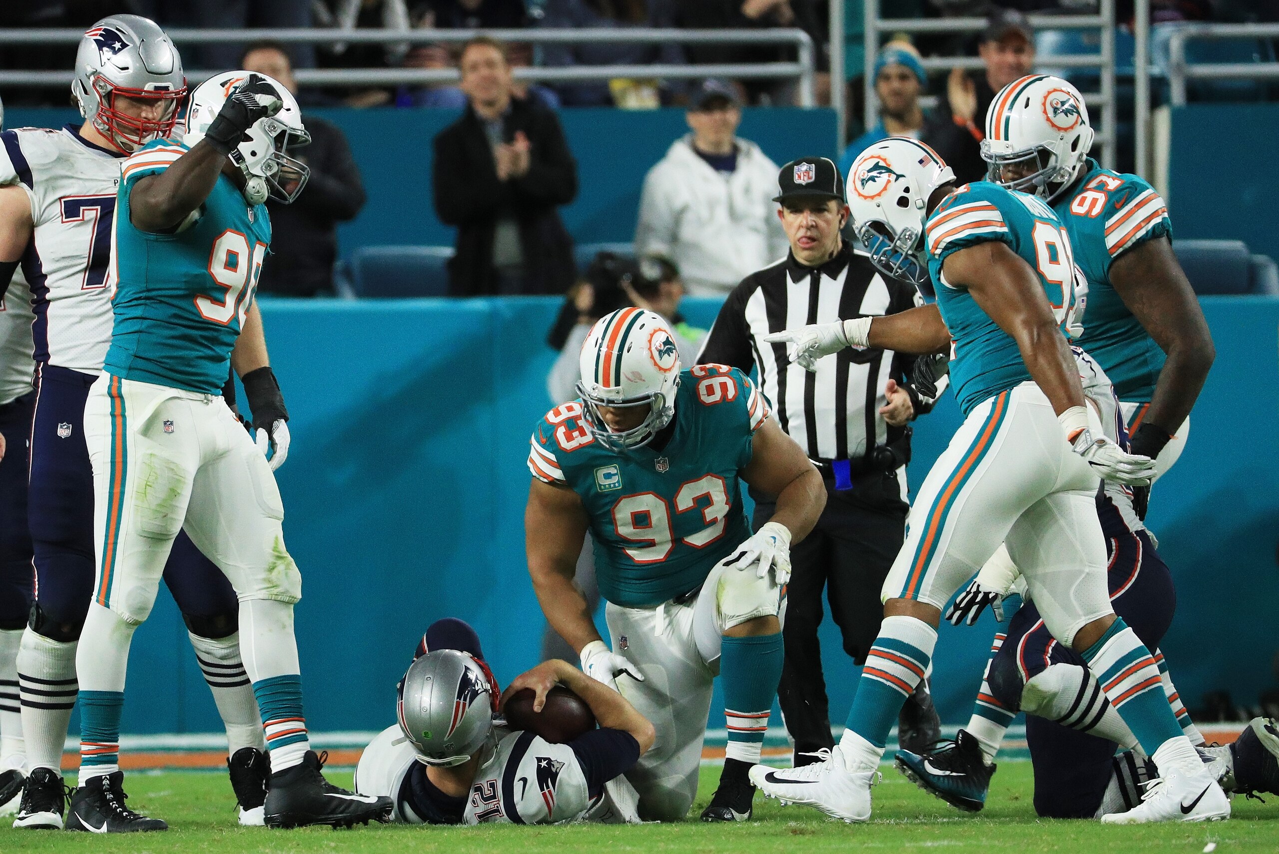 MIAMI GARDENS, FL - DECEMBER 11:  Charles Harris #90  Cameron Wake #91 and  Ndamukong Suh #93 of the Miami Dolphins celebrate sacking  Tom Brady #12 of the New England Patriots in the fourth quarter at Hard Rock Stadium on December 11, 2017 in Miami Garde