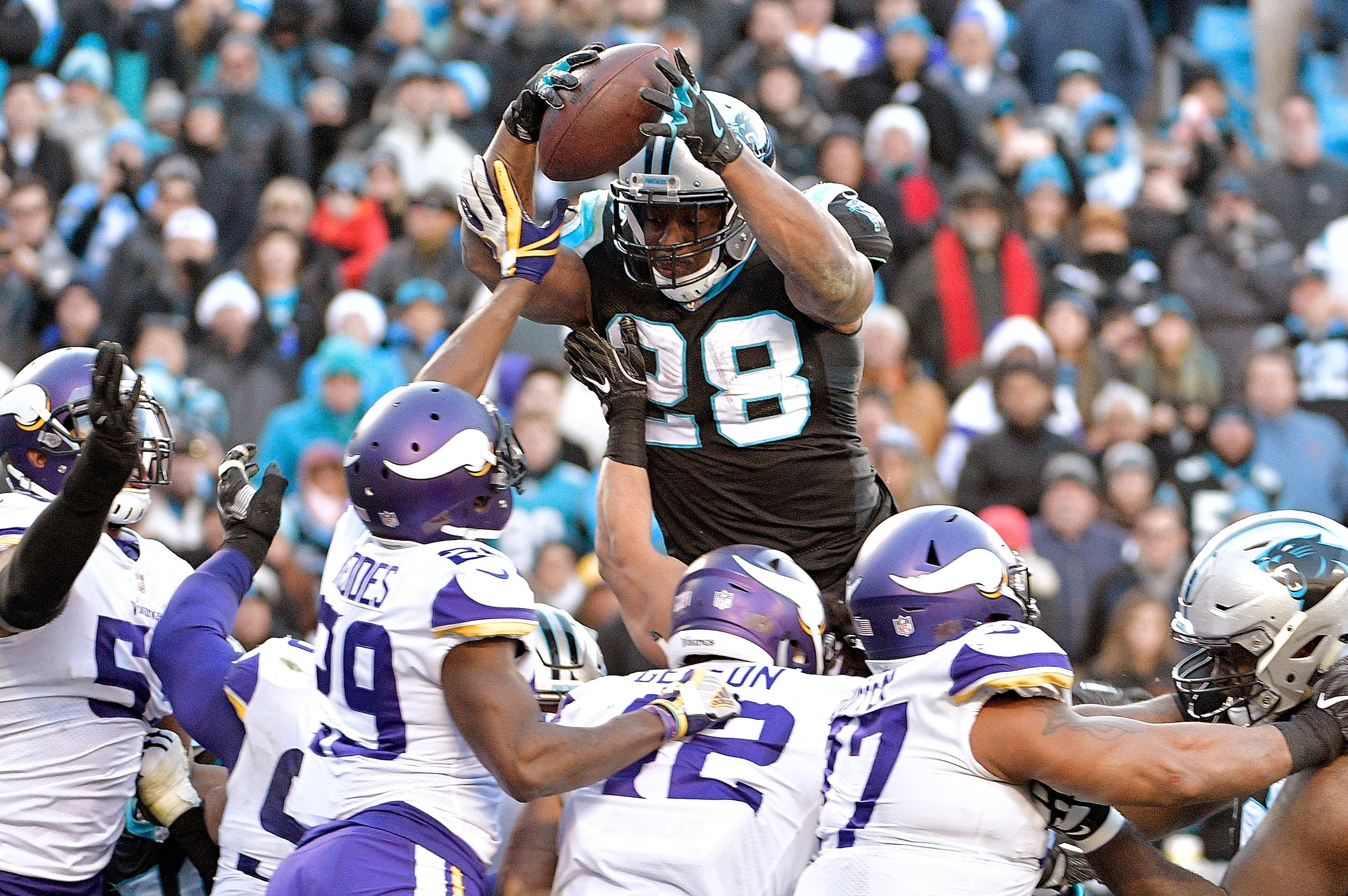 CHARLOTTE, NC - DECEMBER 10:  Jonathan Stewart #28 of the Carolina Panthers leaps into the end zone to score the game-winning touchdown against the Minnesota Vikings during their game at Bank of America Stadium on December 10, 2017 in Charlotte, North Car