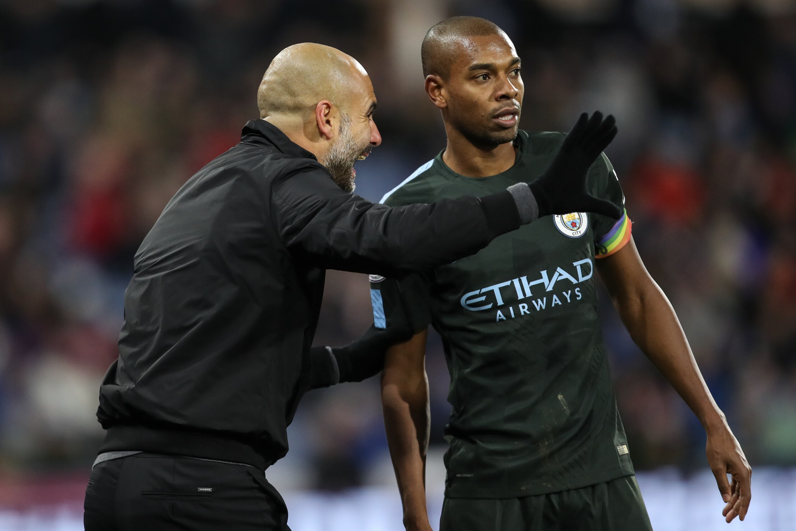 HUDDERSFIELD, ENGLAND - NOVEMBER 26: Pep Guardiola the head coach / manager of Manchester City and Fernandinho of Manchester City during the Premier League match between Huddersfield Town and Manchester City at John Smith's Stadium on November 26, 2017 in