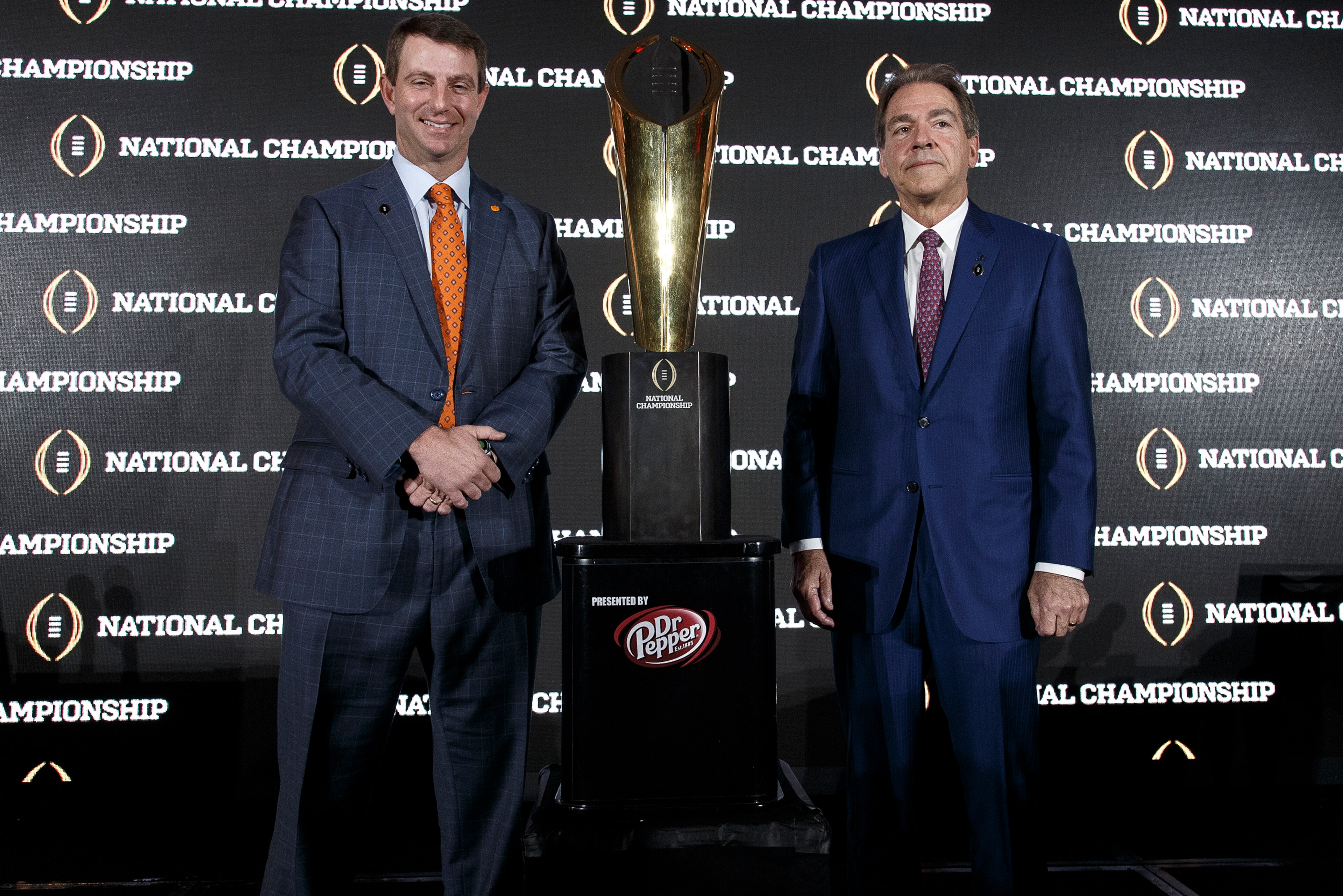 TAMPA, FL - JANUARY 8: Head Coaches Dabo Swinney of the Clemson Tigers and Nick Saban of the Alabama Crimson Tide pose with the National Championship Trophy Presented by Dr. Pepper during the Head Coaches News Confernce before the College Football Playoff