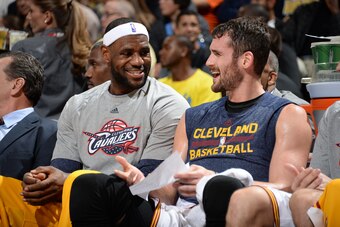 DENVER, CO - NOVEMBER 7:  LeBron James #23 and Kevin Love #0 of the Cleveland Cavaliers share a laugh on the bench during the game against the Denver Nuggets on November 7, 2014 at the Pepsi Center in Denver, Colorado. NOTE TO USER: User expressly acknowl