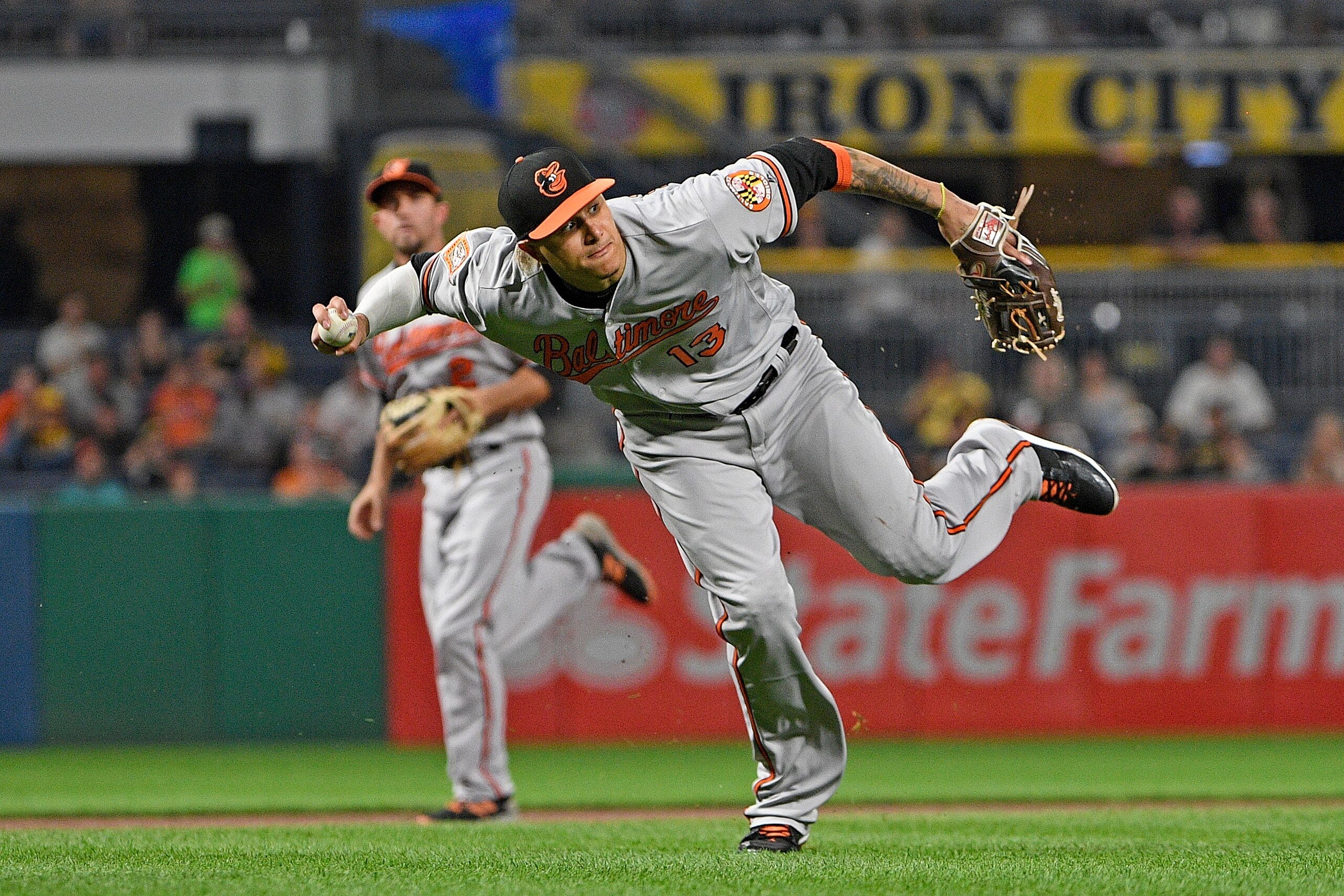 PITTSBURGH, PA - SEPTEMBER 26:  Manny Machado #13 of the Baltimore Orioles attempts a throw to first base but cannot get a force out of David Freese #23 of the Pittsburgh Pirates in the fifth inning during the game at PNC Park on September 26, 2017 in Pit
