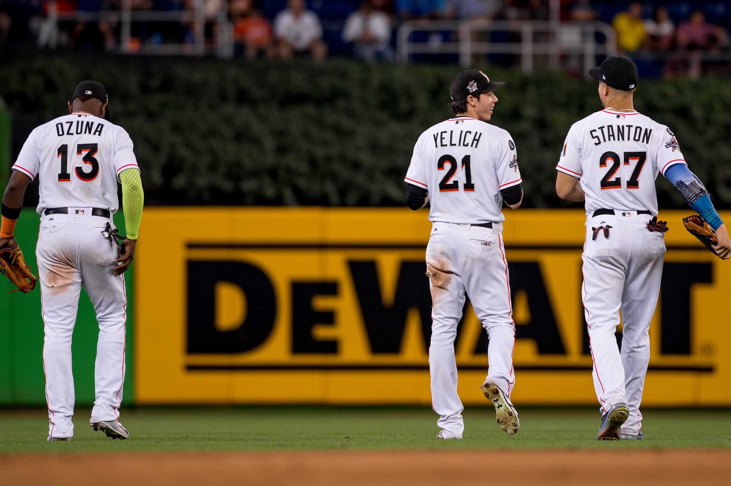 MIAMI, FL - OCTOBER 01: Marcell Ozuna #13, Christian Yelich #21 and Giancarlo Stanton #27 of the Miami Marlins during the game against the Atlanta Braves at Marlins Park on October 1, 2017 in Miami, Florida. (Photo by Rob Foldy/Miami Marlins via Getty Ima