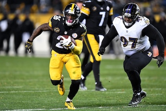 PITTSBURGH, PA - DECEMBER 10: Le'Veon Bell #26 of the Pittsburgh Steelers carries the ball against Michael Pierce #97 of the Baltimore Ravens in the second half during the game at Heinz Field on December 10, 2017 in Pittsburgh, Pennsylvania. (Photo by Joe
