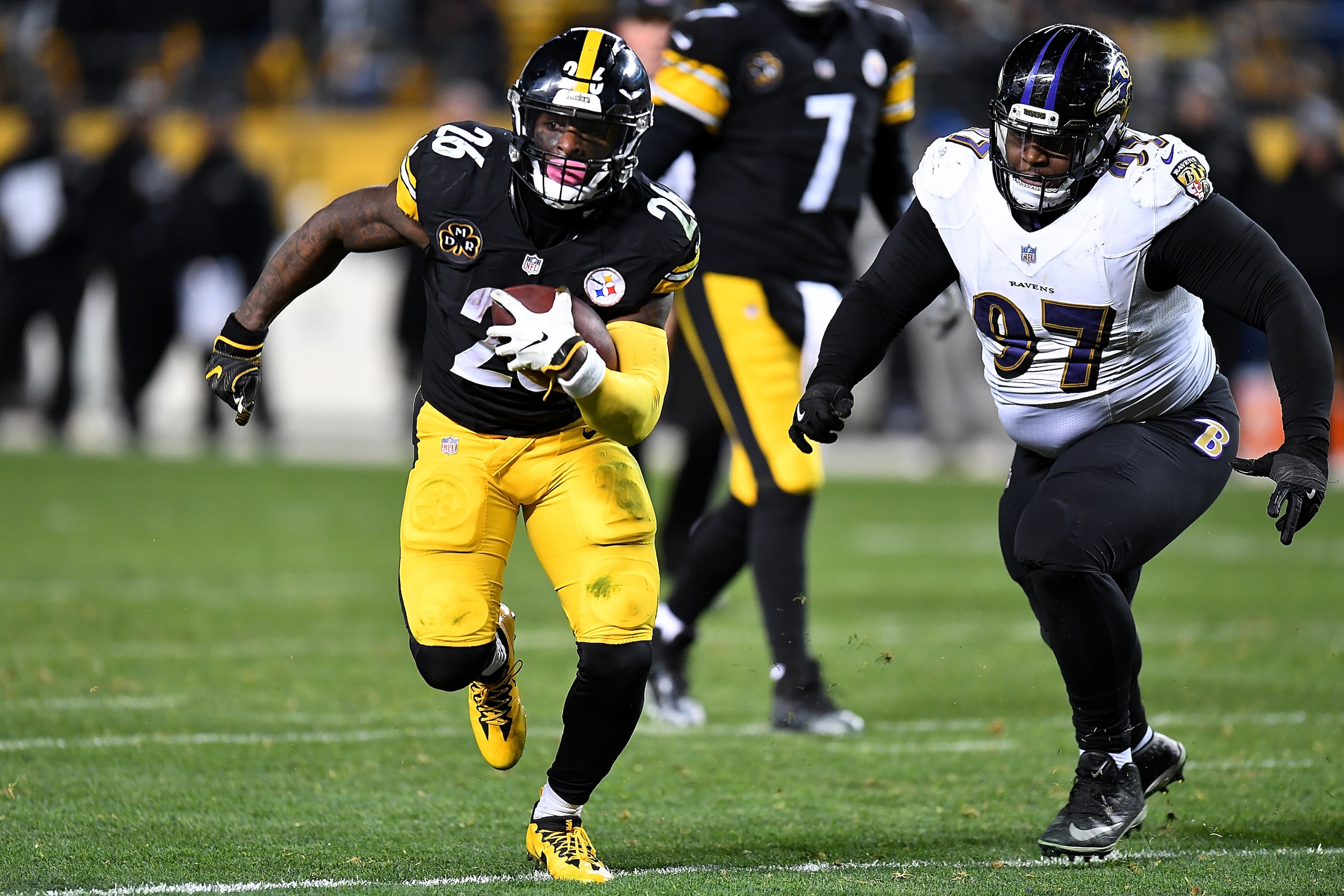 PITTSBURGH, PA - DECEMBER 10: Le'Veon Bell #26 of the Pittsburgh Steelers carries the ball against Michael Pierce #97 of the Baltimore Ravens in the second half during the game at Heinz Field on December 10, 2017 in Pittsburgh, Pennsylvania. (Photo by Joe