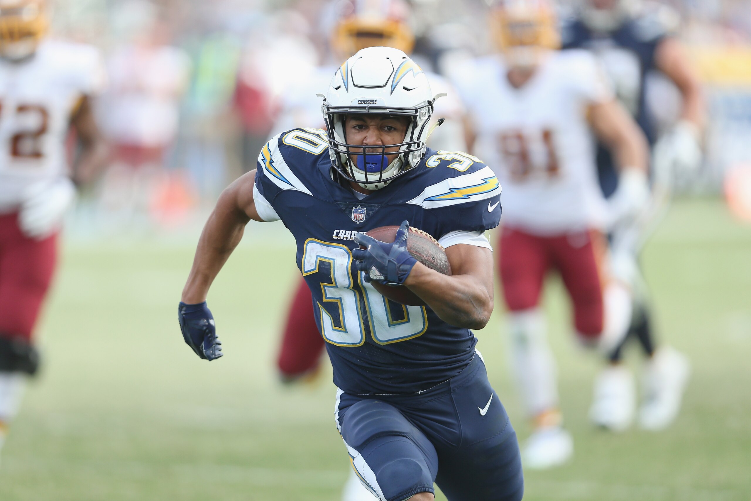 CARSON, CA - DECEMBER 10:  Running back Austin Ekeler #30 of the Los Angeles Chargers carries the ball on a  33 yard run down to the Washington Redskins four yard line on the final play of the first half on December 10, 2017 at StubHub Center in Carson, C