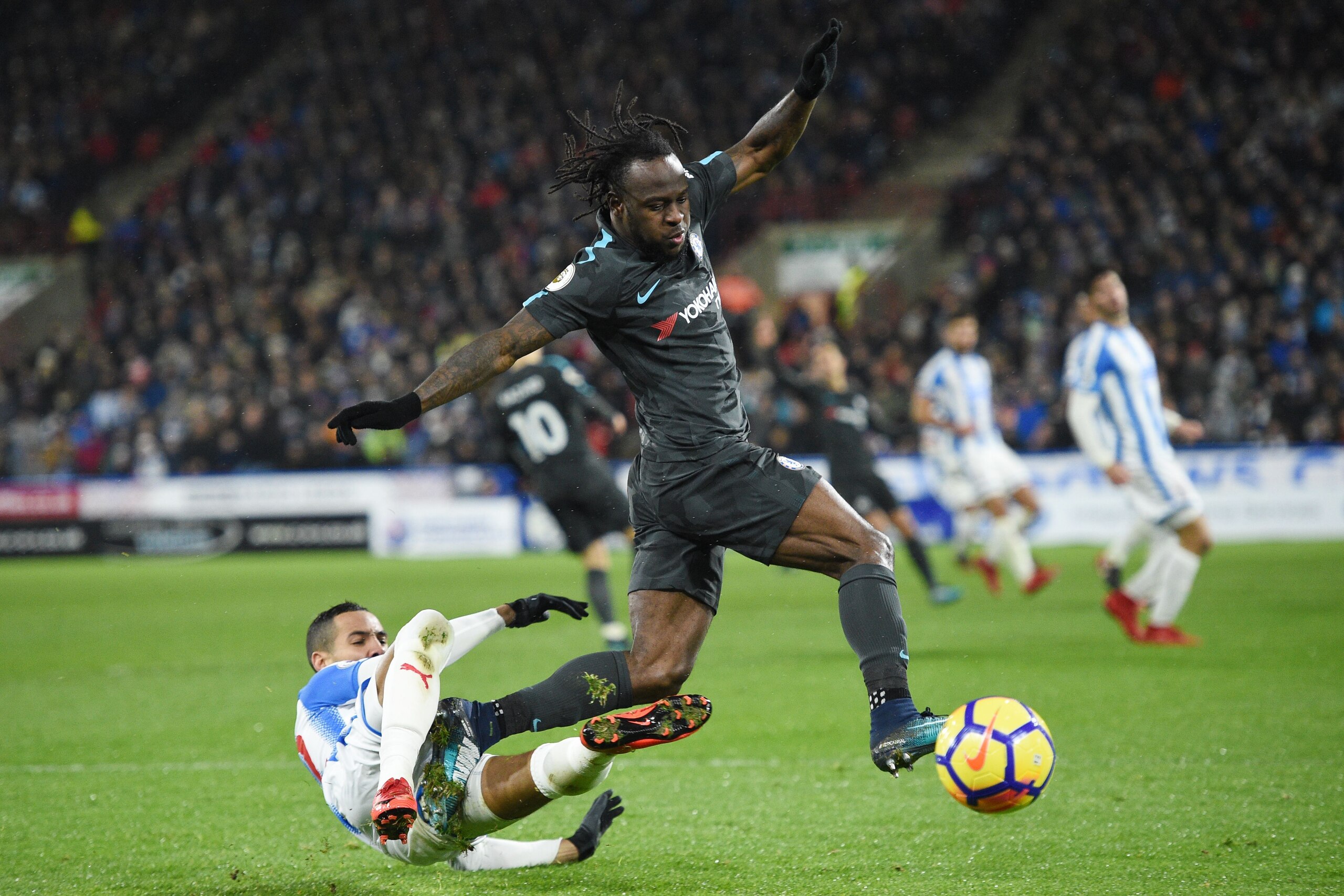 Huddersfield Town's English midfielder Tom Ince (L) tackles Chelsea's Nigerian midfielder Victor Moses during the English Premier League football match between Huddersfield Town and Chelsea at the John Smith's stadium in Huddersfield, northern England on 