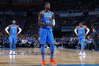 OKLAHOMA CITY, OK- OCTOBER 19:  Paul George #13 shoots a foul shot while Carmelo Anthony #7 and Russell Westbrook #0 of the Oklahoma City Thunder look during the game against the New York Knicks on October 19, 2017 at Chesapeake Energy Arena in Oklahoma C