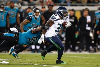 JACKSONVILLE, FL - DECEMBER 10: Runningback Mike Davis #39 of the Seattle Seahawks is tackled by Defensive End Dawuane Smoot #94 of the Jacksonville Jaguars during the game at EverBank Field on December 10, 2017 in Jacksonville, Florida. The Jaguars defea