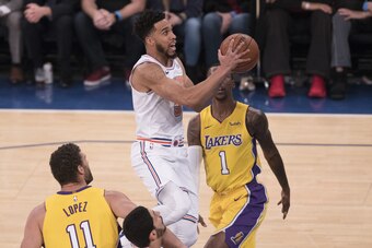 NEW YORK, NY - DECEMBER 12: Courtney Lee #5 of the New York Knicks drives to the basket against Kentavious Caldwell-Pope #1 and Brook Lopez #11 of the Los Angeles Lakers during the NBA game at Madison Square Garden on December 12, 2017 in New York City. N