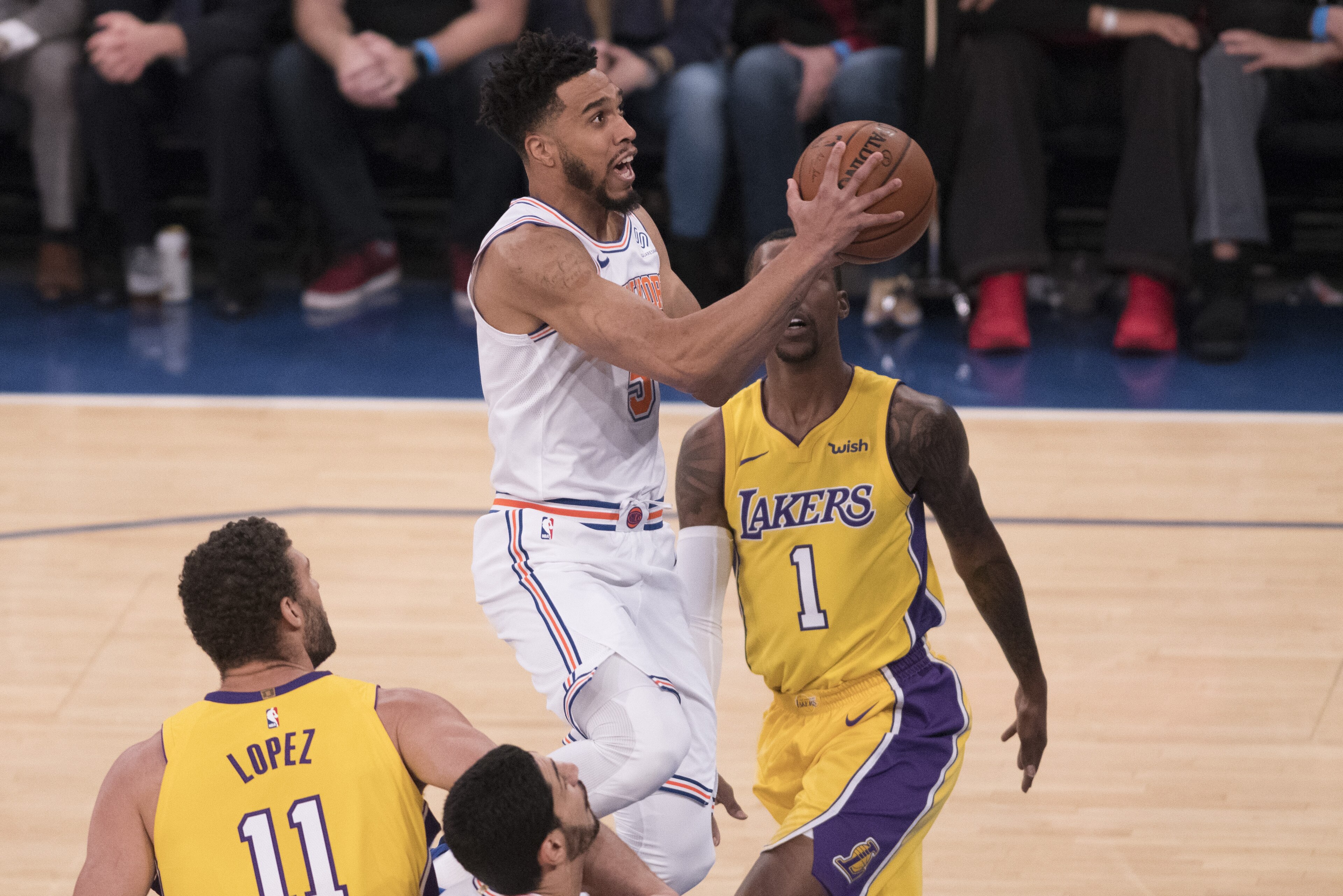 NEW YORK, NY - DECEMBER 12: Courtney Lee #5 of the New York Knicks drives to the basket against Kentavious Caldwell-Pope #1 and Brook Lopez #11 of the Los Angeles Lakers during the NBA game at Madison Square Garden on December 12, 2017 in New York City. N