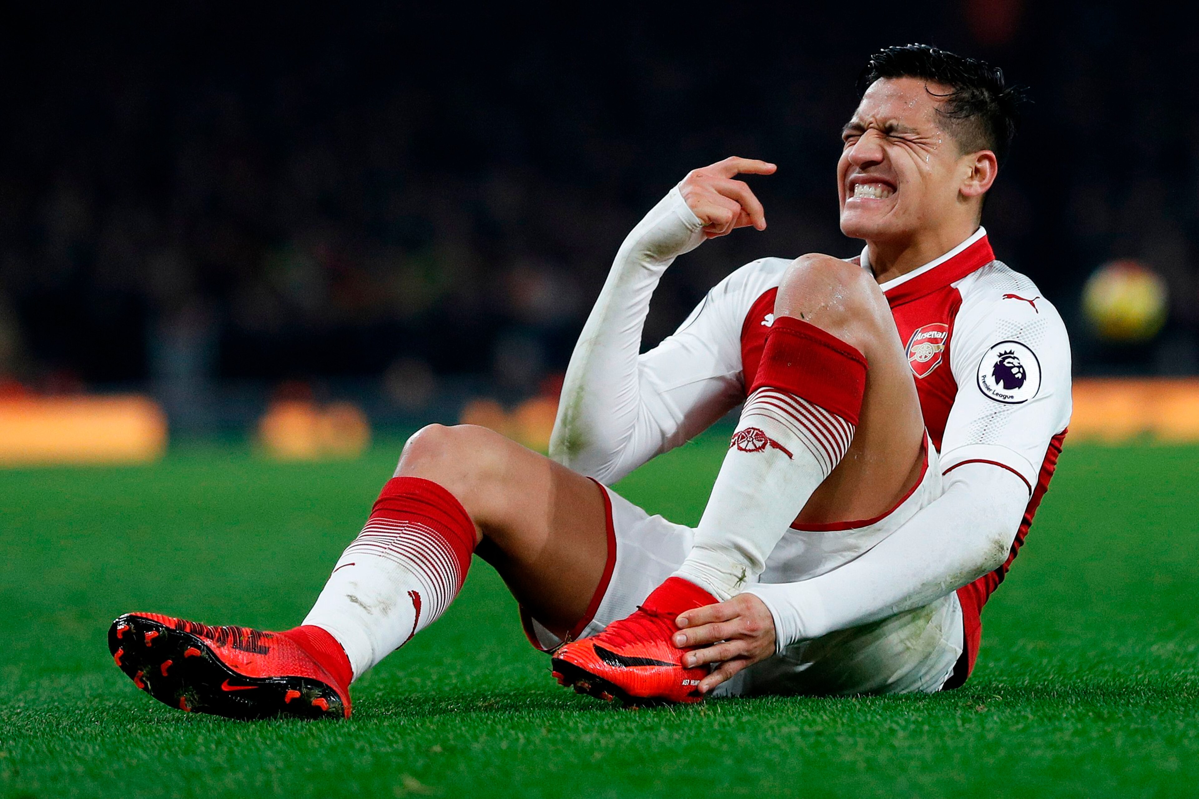 Arsenal's Chilean striker Alexis Sanchez reacts after a challenge from Manchester United's Argentinian defender Marcos Rojo during the English Premier League football match between Arsenal and Manchester United at the Emirates Stadium in London on Decembe