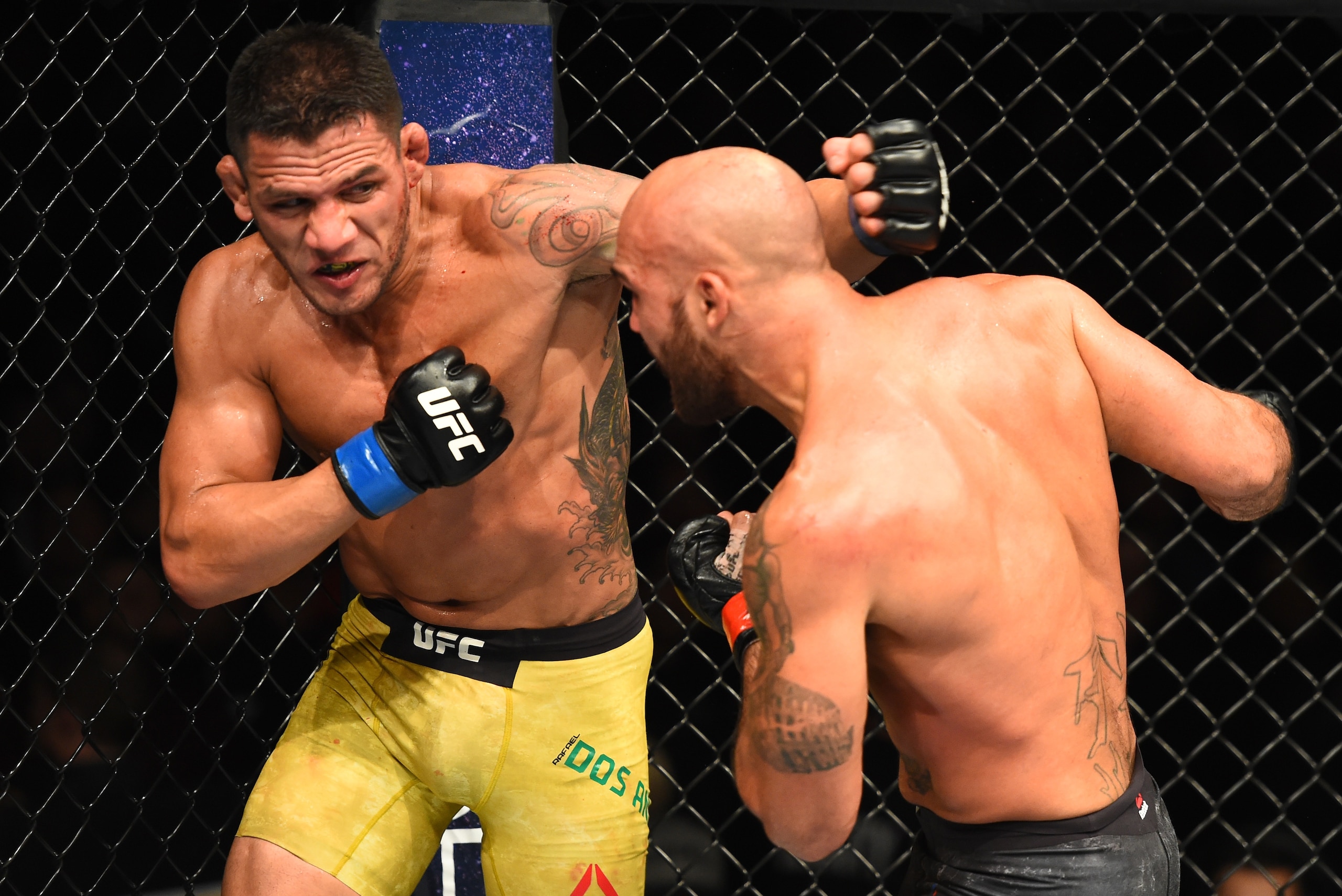 WINNIPEG, CANADA - DECEMBER 16:  (L-R) Rafael Dos Anjos of Brazil punches Robbie Lawler in their welterweight bout during the UFC Fight Night event at Bell MTS Place on December 16, 2017 in Winnipeg, Manitoba, Canada. (Photo by Josh Hedges/Zuffa LLC/Zuffa