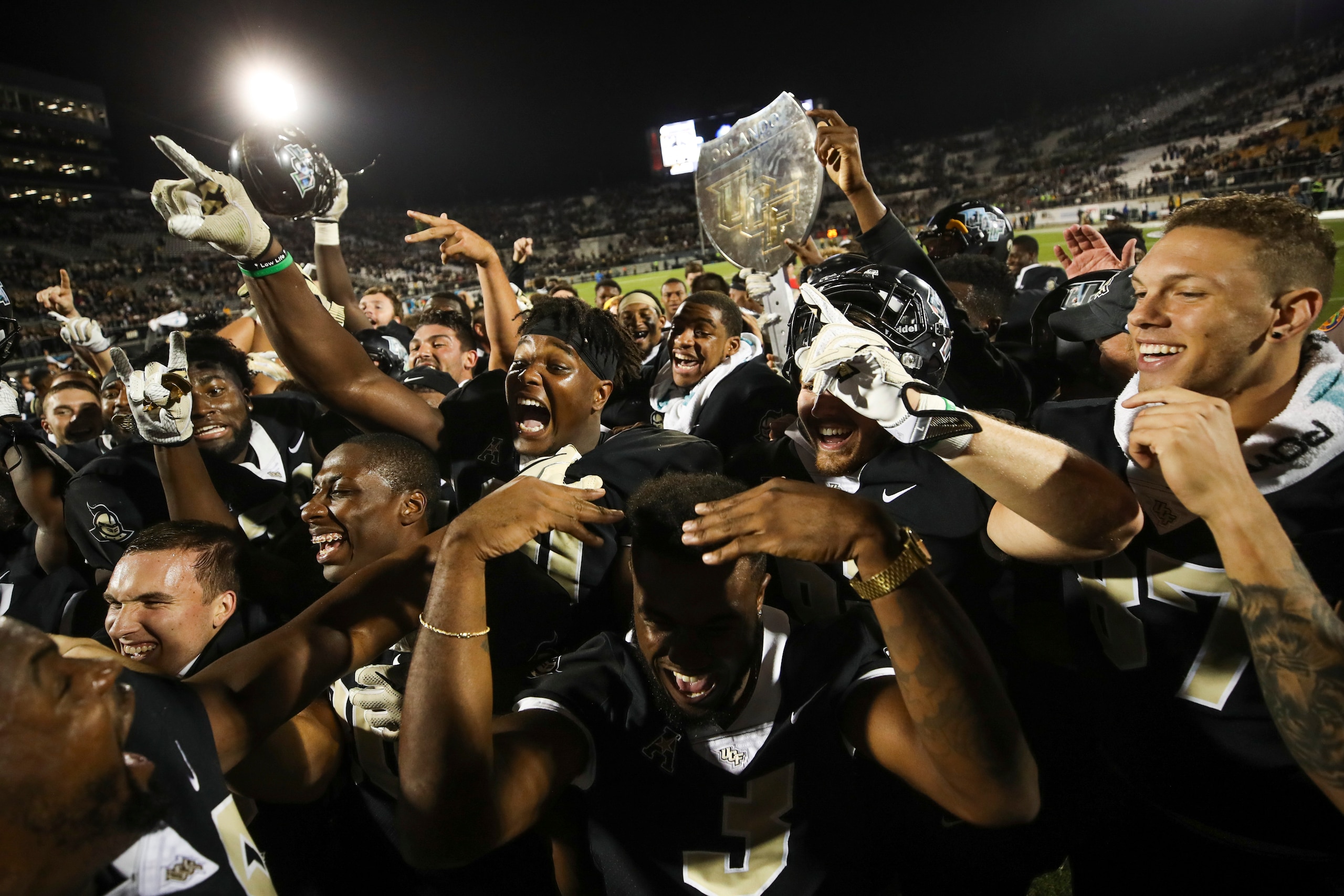 ORLANDO, FL - NOVEMBER 24: The UCF Knights celebrate after a game against the South Florida Bulls at Spectrum Stadium on November 24, 2017 in Orlando, Florida. UCF Knights defeated South Florida Bulls 49-42. (Photo by Logan Bowles/Getty Images) ORLANDO, FL - NOVEMBER 24: The UCF Knights celebrate after a game against the South Florida Bulls at Spectrum Stadium on November 24, 2017 in Orlando, Florida. UCF Knights defeated South Florida Bulls 49-42. (Photo by Logan Bowles/Getty Images)