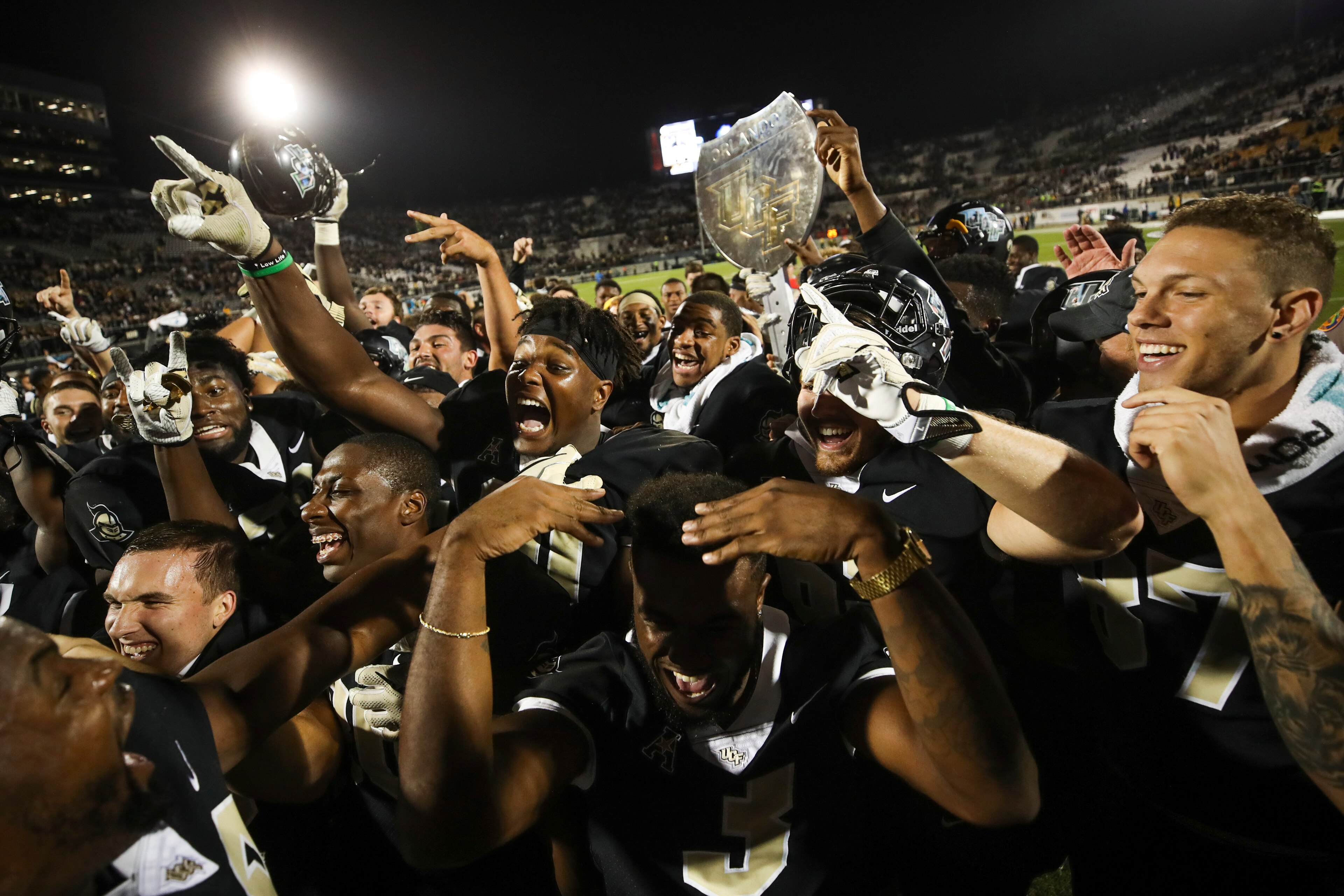 ORLANDO, FL - NOVEMBER 24: The UCF Knights celebrate after a game against the South Florida Bulls at Spectrum Stadium on November 24, 2017 in Orlando, Florida. UCF Knights defeated South Florida Bulls 49-42. (Photo by Logan Bowles/Getty Images)
