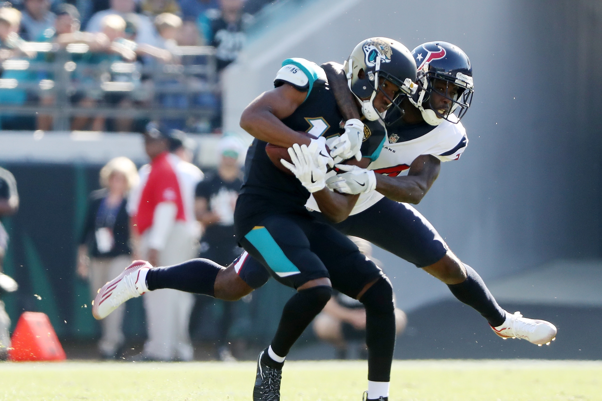 JACKSONVILLE, FL - DECEMBER 17:   Dede Westbrook #12 of the Jacksonville Jaguars is tackled by  Johnathan Joseph #24 of the Houston Texans in the first half of their game at EverBank Field on December 17, 2017 in Jacksonville, Florida.  (Photo by Sam Gree