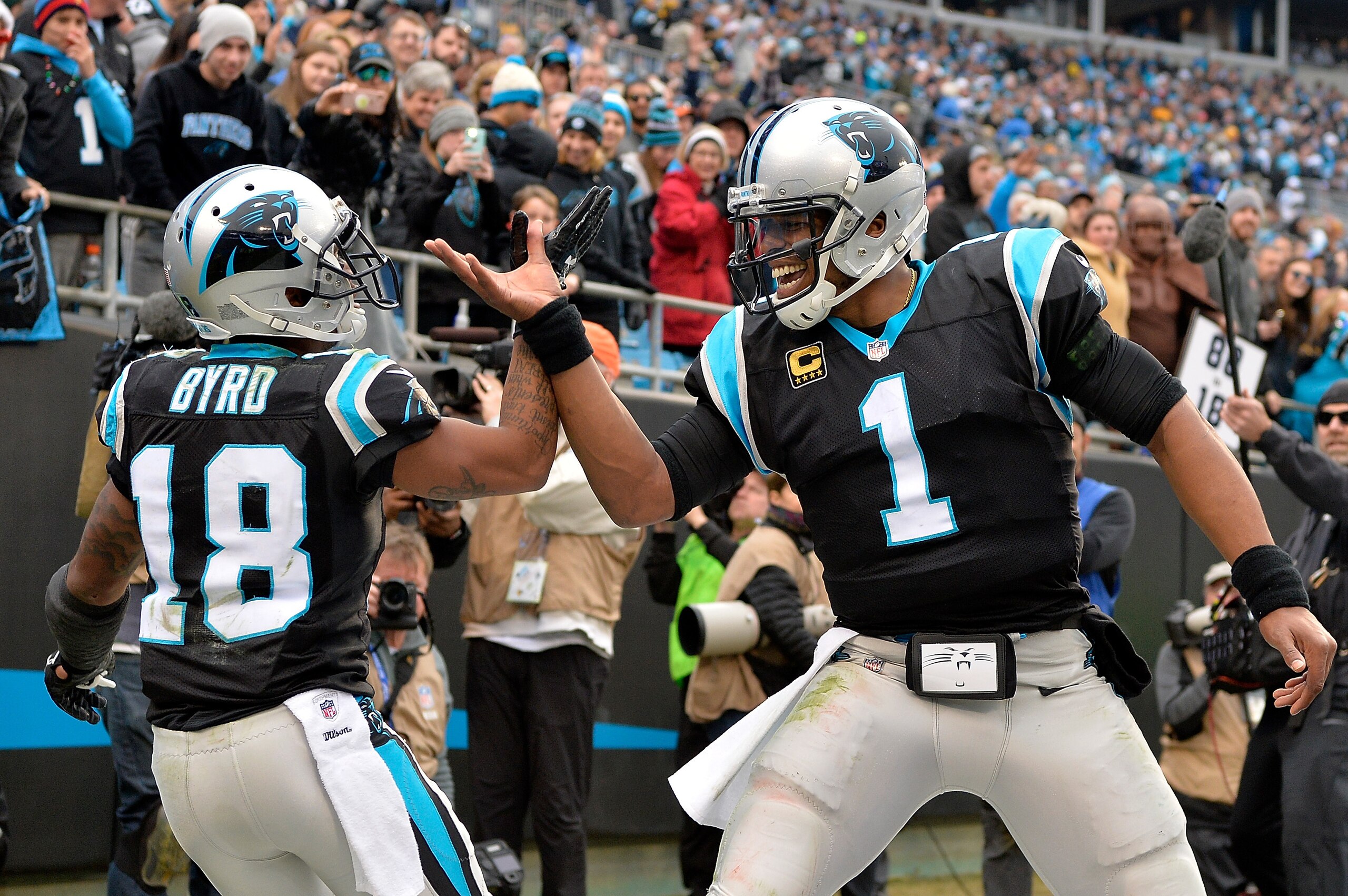 CHARLOTTE, NC - DECEMBER 17: Damiere Byrd #18 celebrates with teammate Cam Newton #1 of the Carolina Panthers after a touchdown against the Green Bay Packers in the fourth quarter during their game at Bank of America Stadium on December 17, 2017 in Charl CHARLOTTE, NC - DECEMBER 17: Damiere Byrd #18 celebrates with teammate Cam Newton #1 of the Carolina Panthers after a touchdown against the Green Bay Packers in the fourth quarter during their game at Bank of America Stadium on December 17, 2017 in Charl