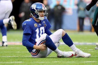 EAST RUTHERFORD, NJ - DECEMBER 17:  Eli Manning #10 of the New York Giants lays on the ground after a play against the Philadelphia Eagles during the second quarter in the game at MetLife Stadium on December 17, 2017 in East Rutherford, New Jersey.  (Phot