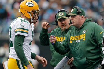Green Bay Packers head coach Mike McCarthy talks with quarterback Aaron Rodgers during Sunday's 31-24 loss to the Carolina Panthers.