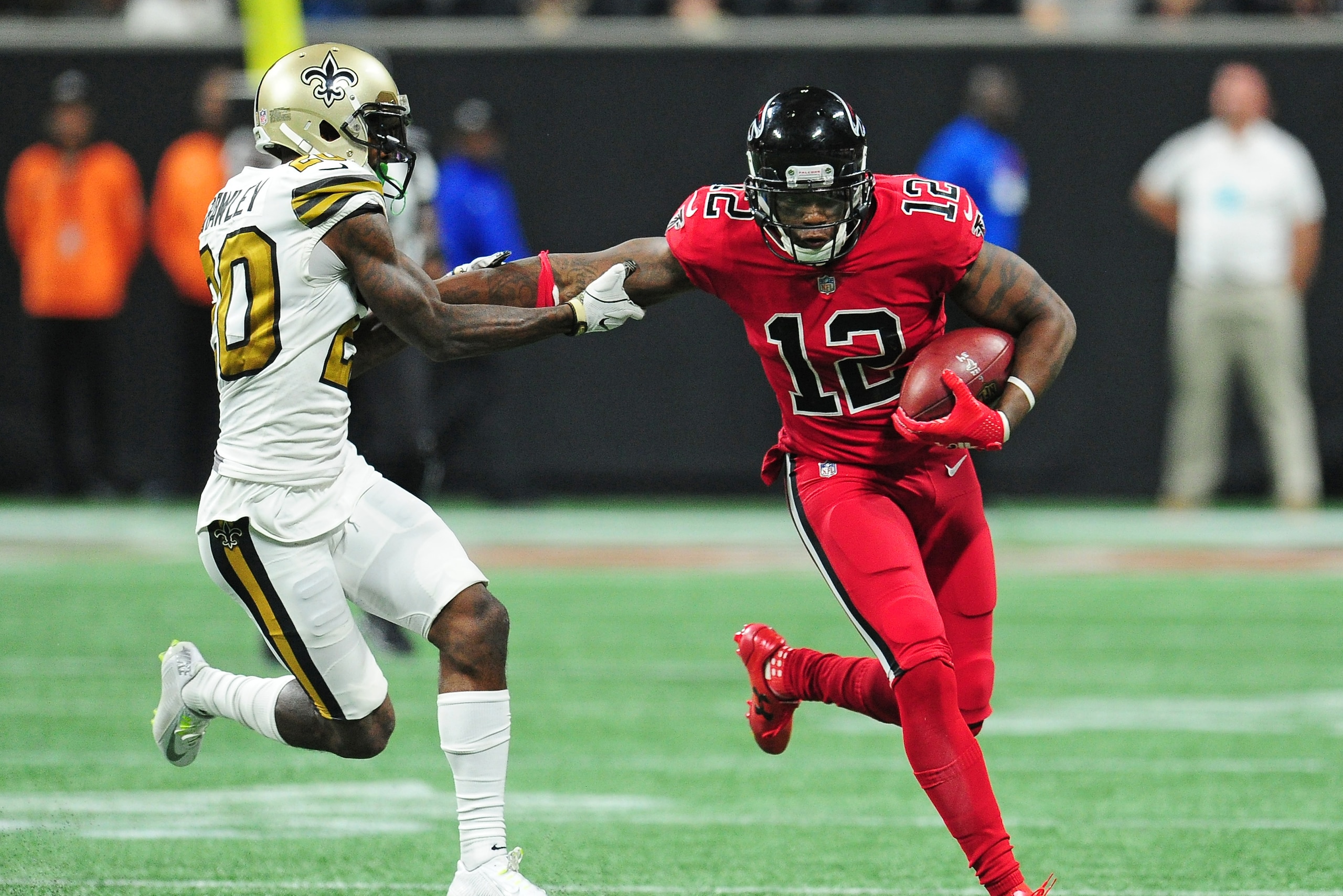 ATLANTA, GA - DECEMBER 7: Mohamed Sanu #12 of the Atlanta Falcons tries to escape the tackle attempt by Ken Crawley #20 of the New Orleans Saints at Mercedes-Benz Stadium on December 7, 2017 in Atlanta, Georgia. (Photo by Scott Cunningham/Getty Images)
