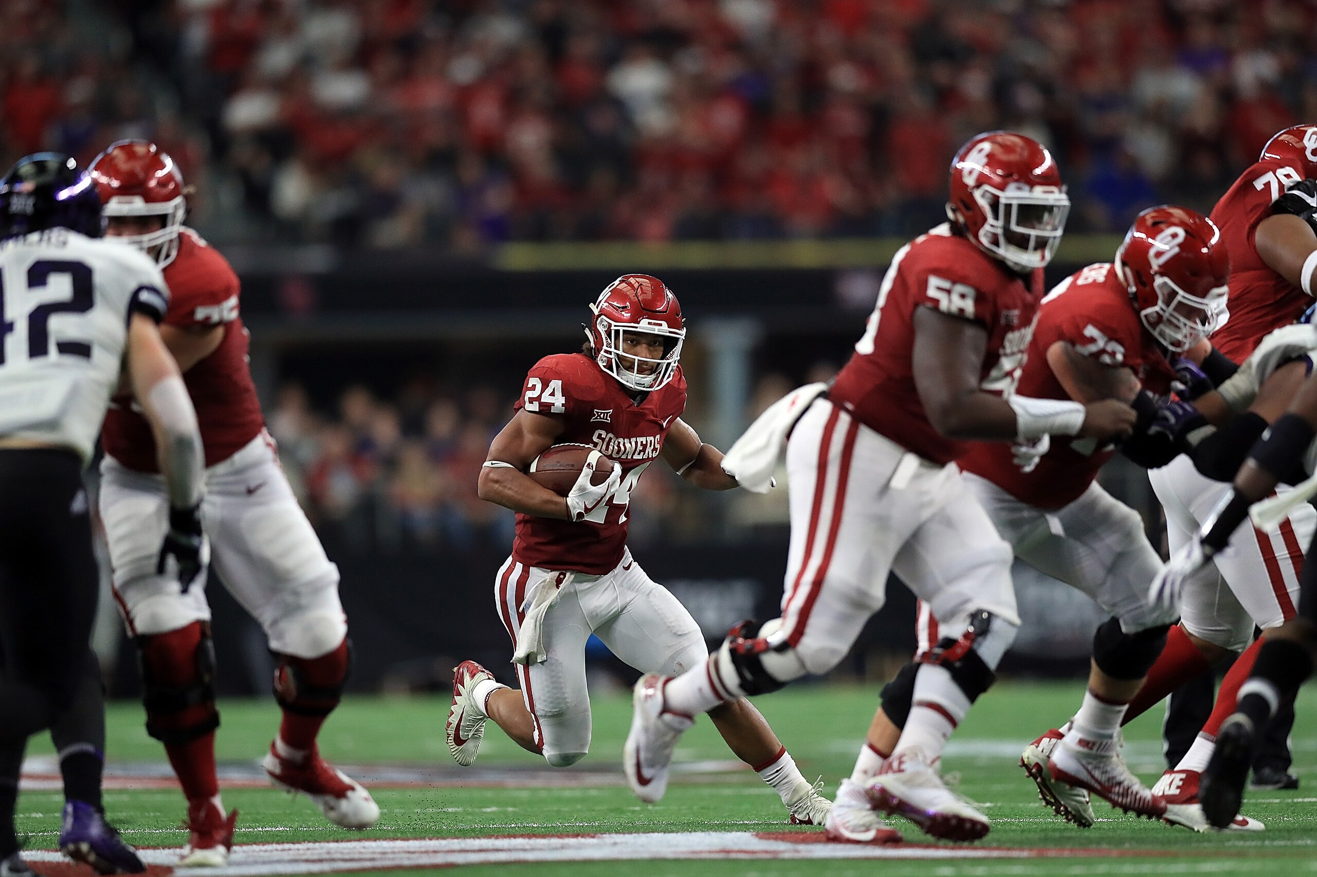 ARLINGTON, TX - DECEMBER 02:  Rodney Anderson #24 of the Oklahoma Sooners runs the ball against the TCU Horned Frogs in the second quarter during Big 12 Championship at AT&T Stadium on December 2, 2017 in Arlington, Texas.  (Photo by Ronald Martinez/Getty