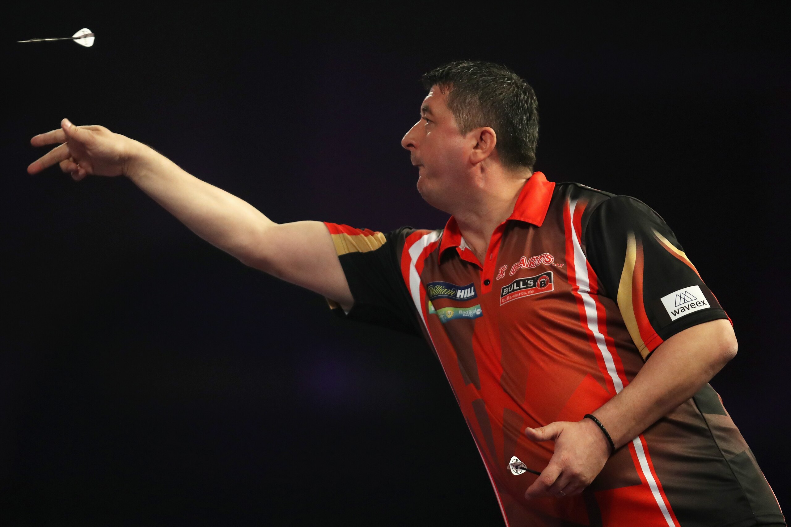 LONDON, ENGLAND - DECEMBER 18:  Mensur Suljovic of Austria in action during his first round match against Kevin Painter of England on day five of the 2018 William Hill PDC World Darts Championships at Alexandra Palace on December 18, 2017 in London, Engla