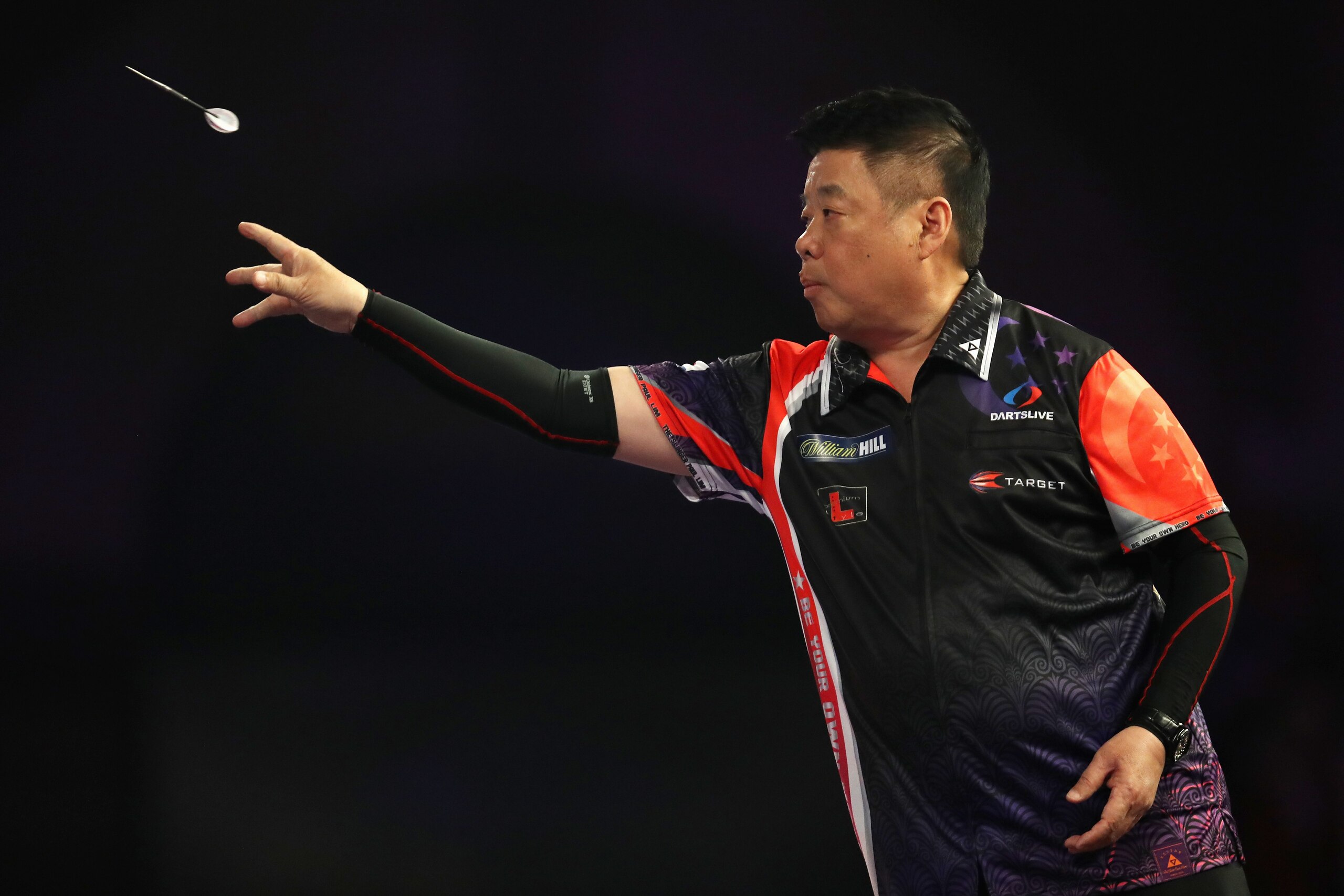 LONDON, ENGLAND - DECEMBER 18: Paul Lim of Singapore in action during his preliminary round match against Kai Fan Leung of China on day five of the 2018 William Hill PDC World Darts Championships at Alexandra Palace on December 18, 2017 in London, England