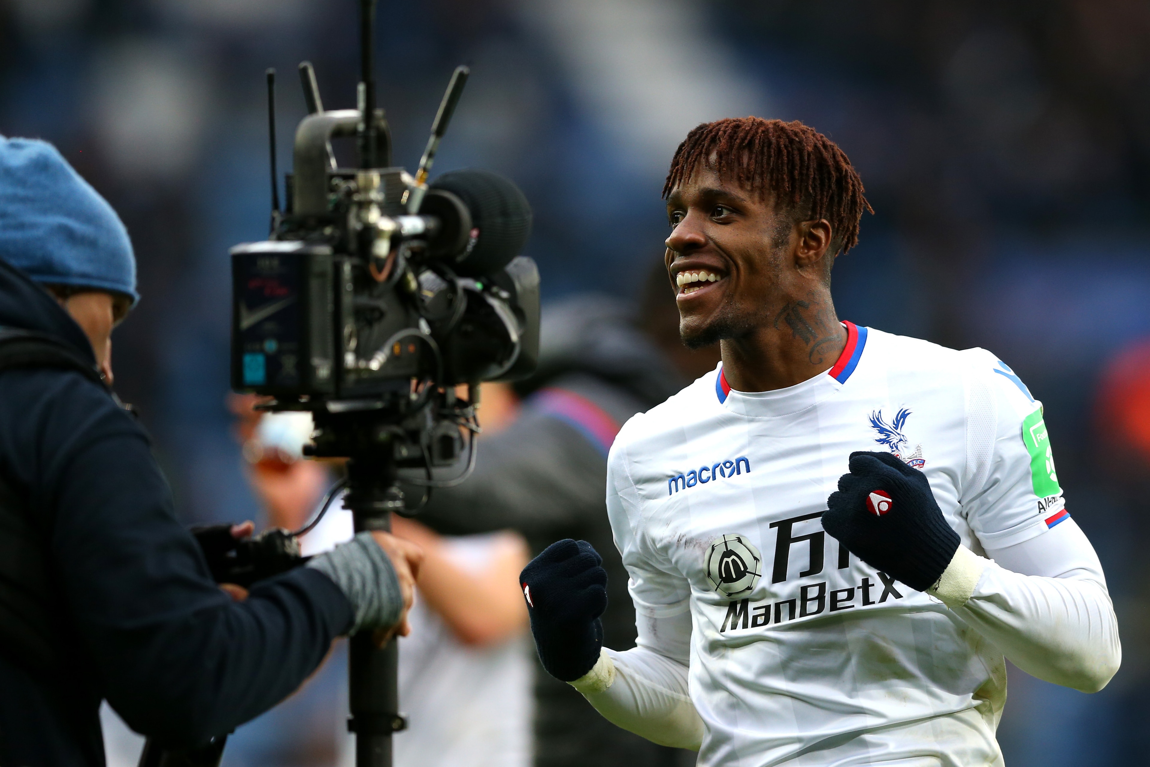 LEICESTER, ENGLAND - DECEMBER 16: Wilfried Zaha of Crystal Palace celebrates victory after the Premier League match between Leicester City and Crystal Palace at The King Power Stadium on December 16, 2017 in Leicester, England.  (Photo by Jan Kruger/Getty