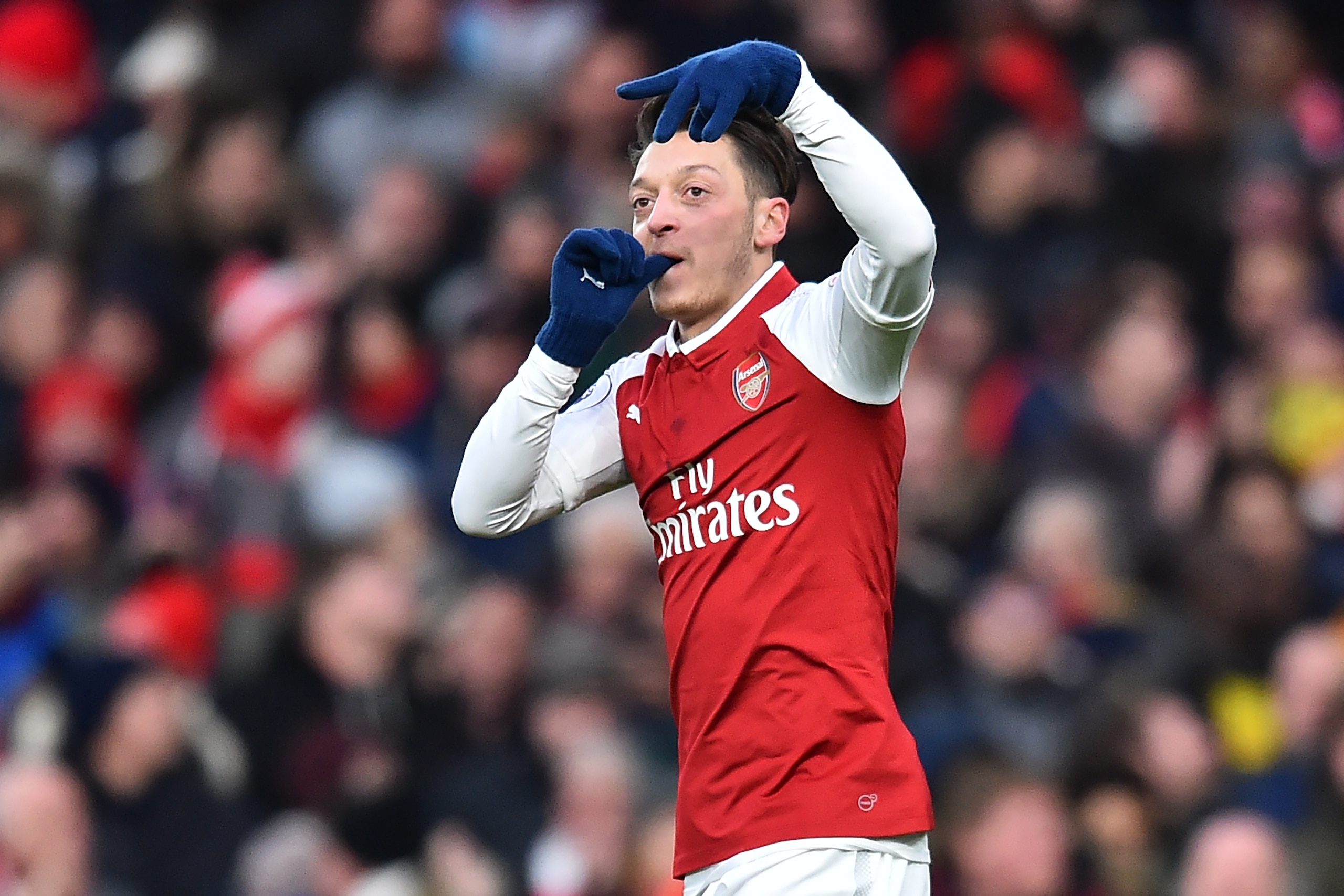 Arsenal's German midfielder Mesut Ozil celebrates after scoring the opening goal of the English Premier League football match between Arsenal and Newcastle United at the Emirates Stadium in London on December 16, 2017.  / AFP PHOTO / Glyn KIRK / RESTRICTE