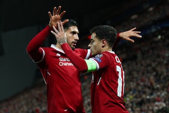 LIVERPOOL, ENGLAND - DECEMBER 06: Philippe Coutinho of Liverpool celebrates after scoring his sides second goal with Emre Can of Liverpool during the UEFA Champions League group E match between Liverpool FC and Spartak Moskva at Anfield on December 6, 201