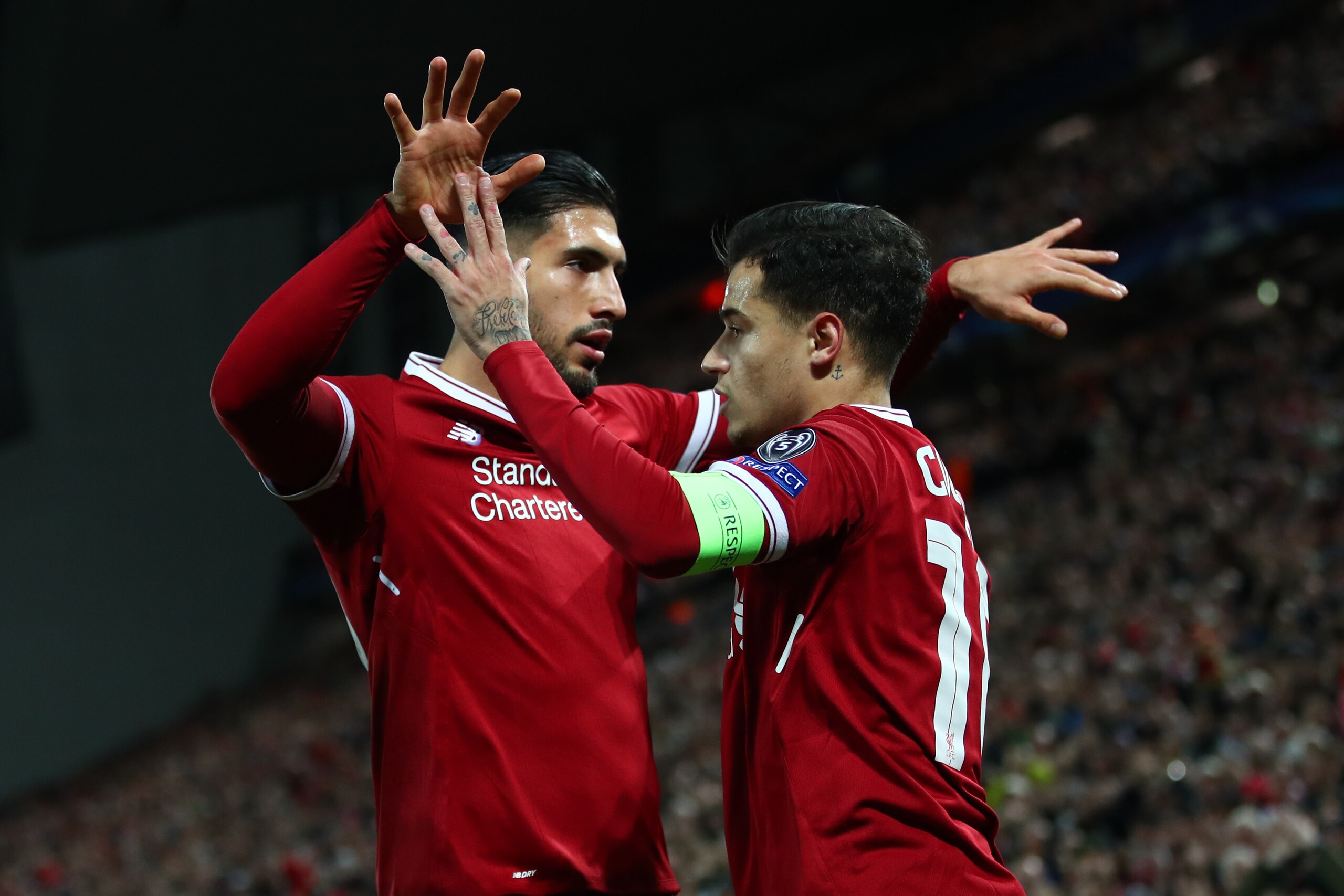 LIVERPOOL, ENGLAND - DECEMBER 06: Philippe Coutinho of Liverpool celebrates after scoring his sides second goal with Emre Can of Liverpool during the UEFA Champions League group E match between Liverpool FC and Spartak Moskva at Anfield on December 6, 201