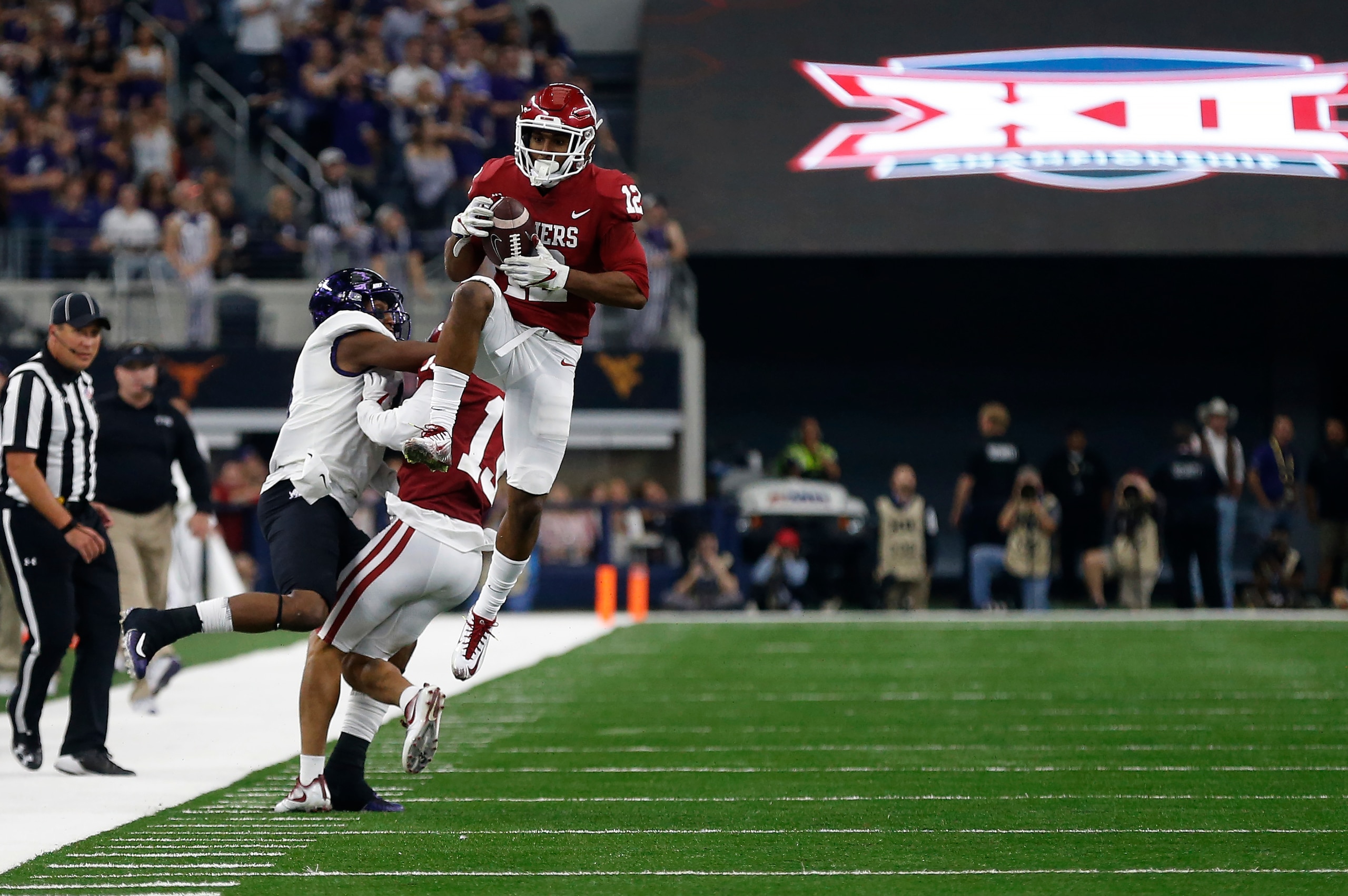 ARLINGTON, TX - DECEMBER 2: Will Johnson #12 of the Oklahoma Sooners intercepts in front of John Diarse #9 of the TCU Horned Frogs in the second half of the Big 12 Championship AT&T Stadium on December 2, 2017 in Arlington, Texas. OU won 41-17. (Photo by 