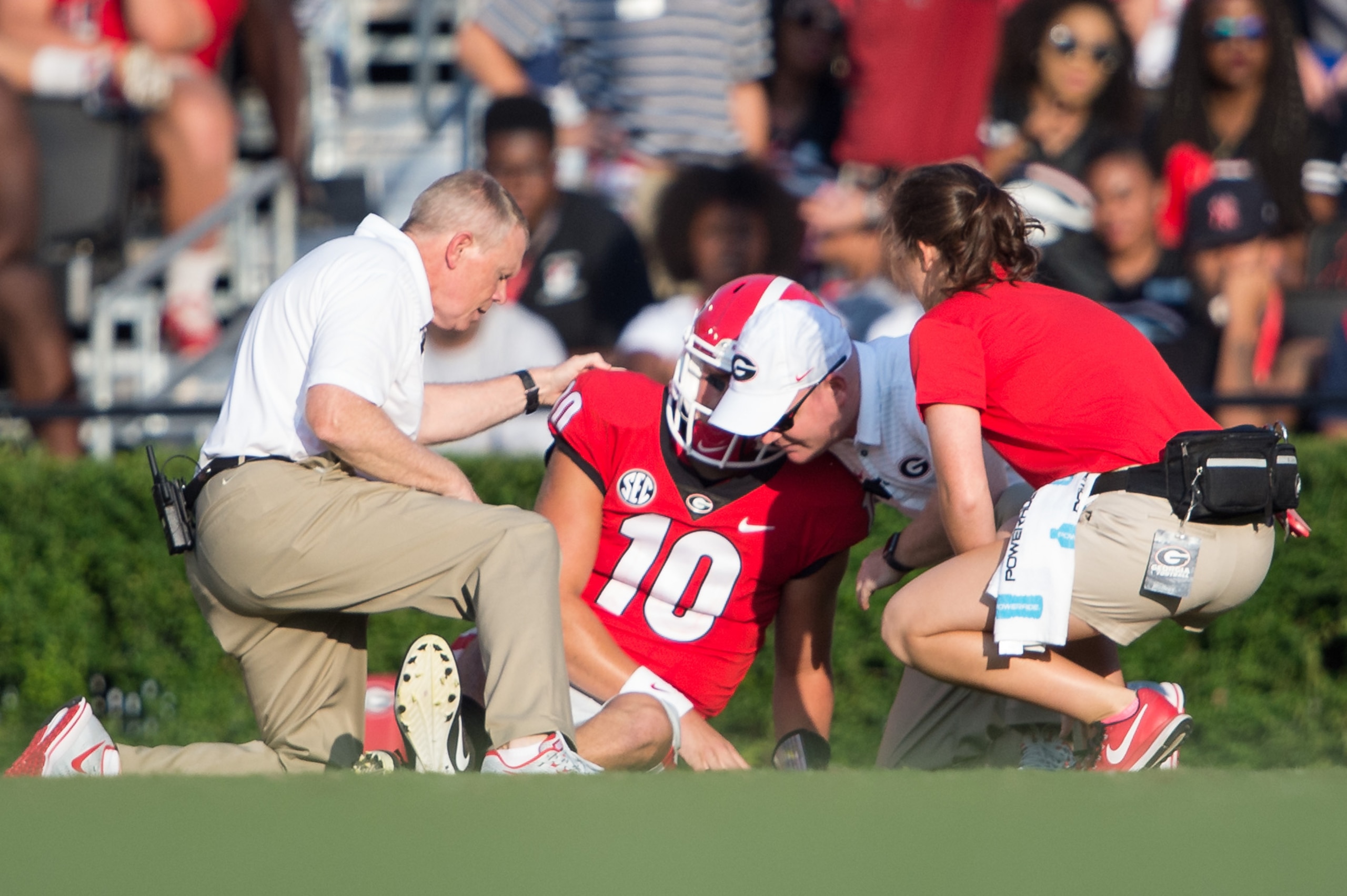 ATHENS, GA - SEPTEMBER 2: Quarterback Jacob Eason #10 of the Georgia Bulldogs gets help from trainers after injuring his leg during their game against the Appalachian State Mountaineers at Sanford Stadium on September 2, 2017 in Athens, Georgia. The Georg