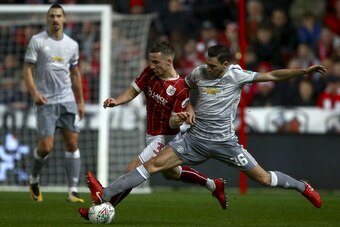 Bristol City`s Joe Bryan (L) vies for the ball with Manchester United`s Matteo Darmian (R) during the English League Cup quarter-final football match between Bristol City and Manchester United at Ashton Gate Stadium in Bristol, southwest England on Decemb