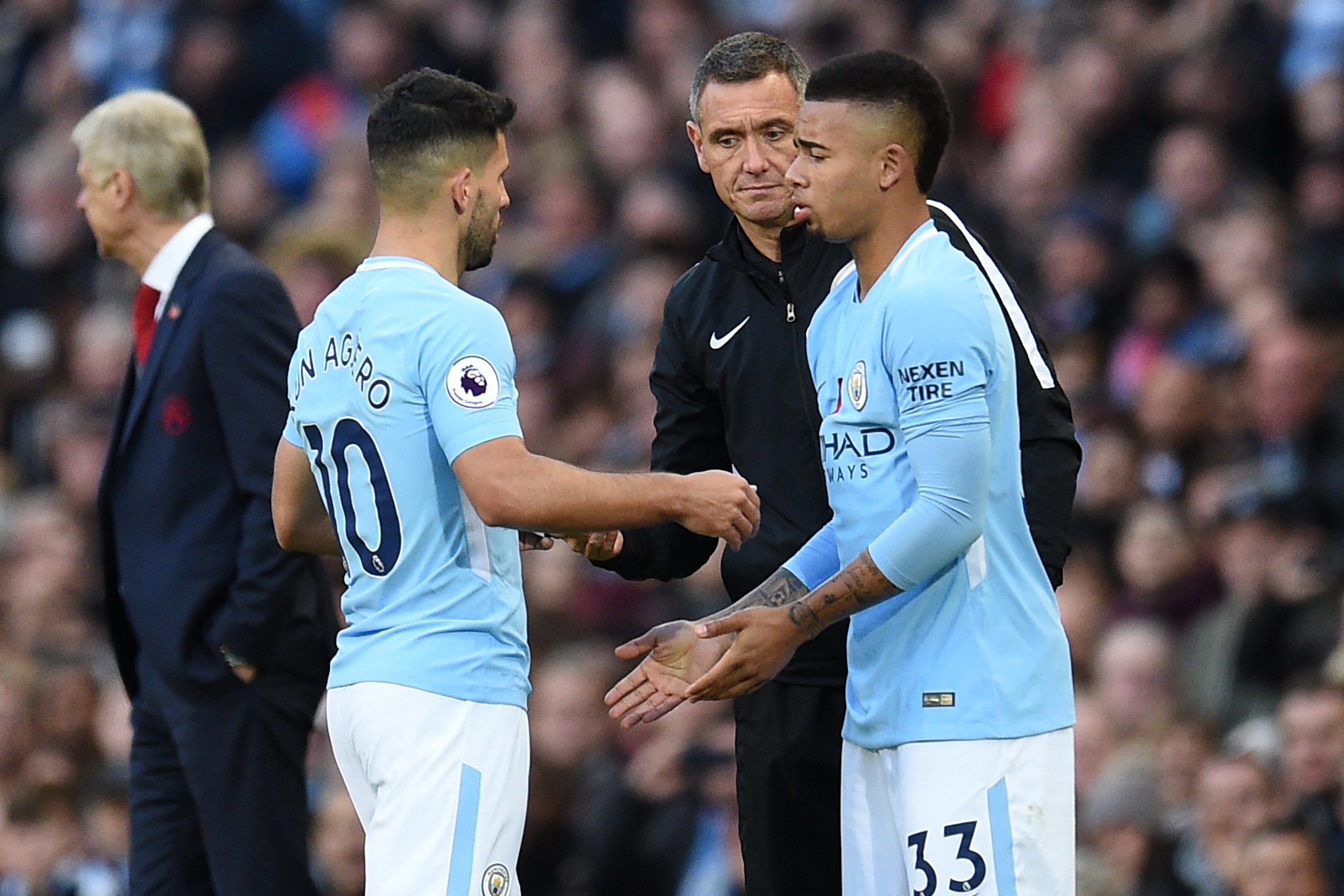 Manchester City's Argentinian striker Sergio Aguero (L) is substituted for Manchester City's Brazilian striker Gabriel Jesus during the English Premier League football match between Manchester City and Arsenal at the Etihad Stadium in Manchester, north we
