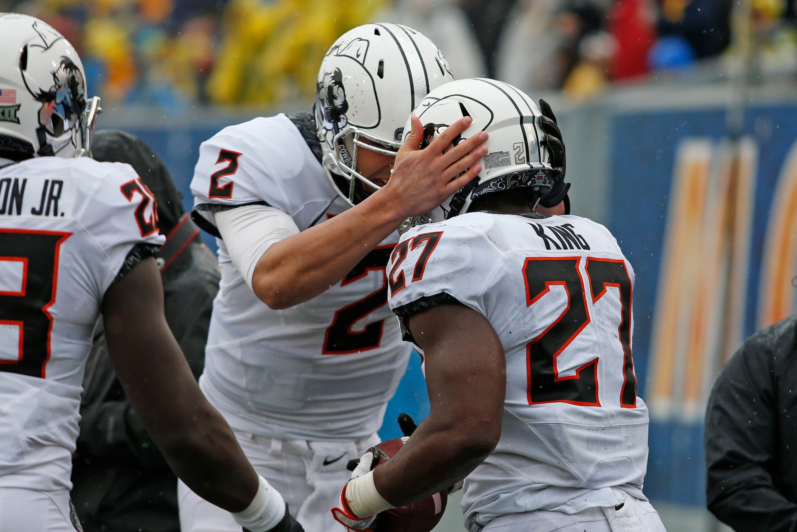 MORGANTOWN, WV - OCTOBER 28:  Mason Rudolph #2 of the Oklahoma State Cowboys celebrates with J.D. King #27 of the Oklahoma State Cowboys in the second half against the West Virginia Mountaineers at Mountaineer Field on October 28, 2017 in Morgantown, West