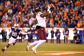 CHARLOTTESVILLE, VA - NOVEMBER 24: Cam Phillips #5 of the Virginia Tech Hokies catches a pass in the third quarter during a game against the Virginia Cavaliers at Scott Stadium on November 24, 2017 in Charlottesville, Virginia. Virginia Tech defeated Virg