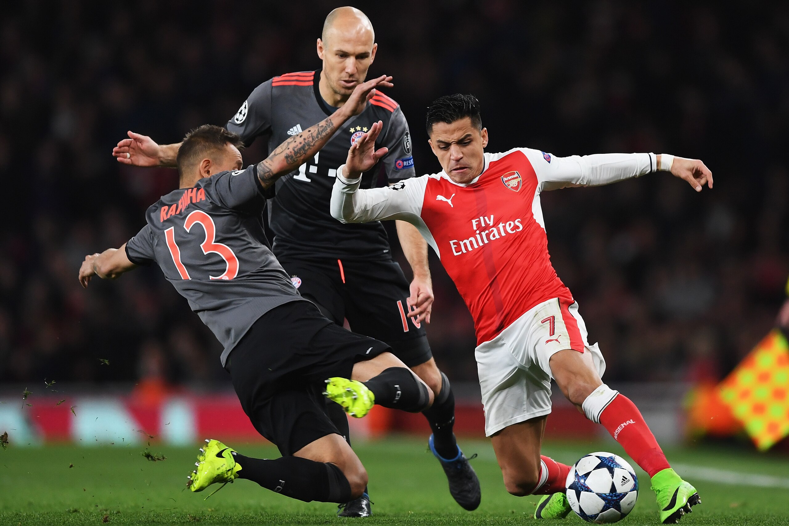 LONDON, ENGLAND - MARCH 07: Alexis Sanchez of Arsenal battles with Rafinha (13) and Arjen Robben of Bayern Muenchen during the UEFA Champions League Round of 16 second leg match between Arsenal FC and FC Bayern Muenchen at Emirates Stadium on March 7, 20 LONDON, ENGLAND - MARCH 07: Alexis Sanchez of Arsenal battles with Rafinha (13) and Arjen Robben of Bayern Muenchen during the UEFA Champions League Round of 16 second leg match between Arsenal FC and FC Bayern Muenchen at Emirates Stadium on March 7, 20