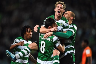 Sporting's Portuguese midfielder Bruno Fernandes (L) celebrates with Sporting's Dutch forward Bas Dost (C) and Sporting's forward Daniel Podence (R) after scoring during the Portuguese league football match Sporting CP against Portimonense SC at the Jose 