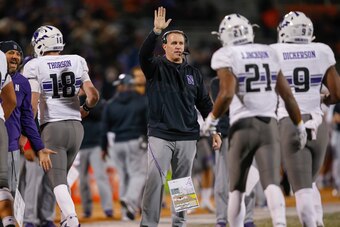 CHAMPAIGN, IL - NOVEMBER 25: Head coach Pat Fitzgerald of the Northwestern Wildcats celebrates with members of the team after a score against the Illinois Fighting Illini at Memorial Stadium on November 25, 2017 in Champaign, Illinois. (Photo by Michael H