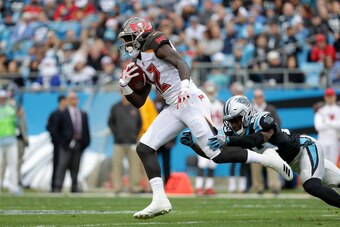 CHARLOTTE, NC - DECEMBER 24:  Chris Godwin #12 of the Tampa Bay Buccaneers runs the ball against the Carolina Panthers in the second quarter during their game at Bank of America Stadium on December 24, 2017 in Charlotte, North Carolina.  (Photo by Streete