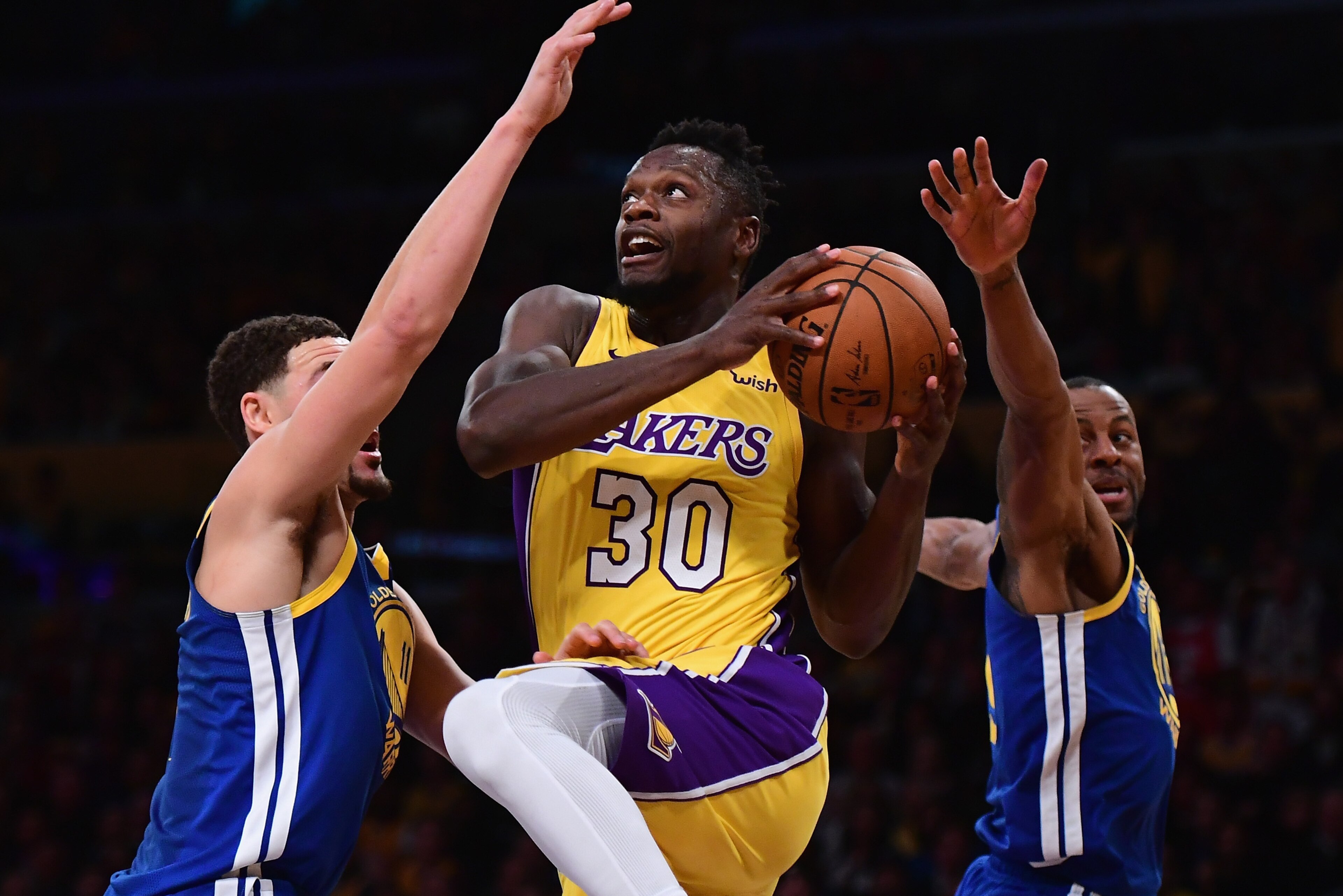LOS ANGELES, CA - DECEMBER 18:  Julius Randle #30 of the Los Angeles Lakers drives between Klay Thompson #11 and Andre Iguodala #9 during a 116-114 Warrior overtime win at Staples Center on December 18, 2017 in Los Angeles, California.  (Photo by Harry Ho