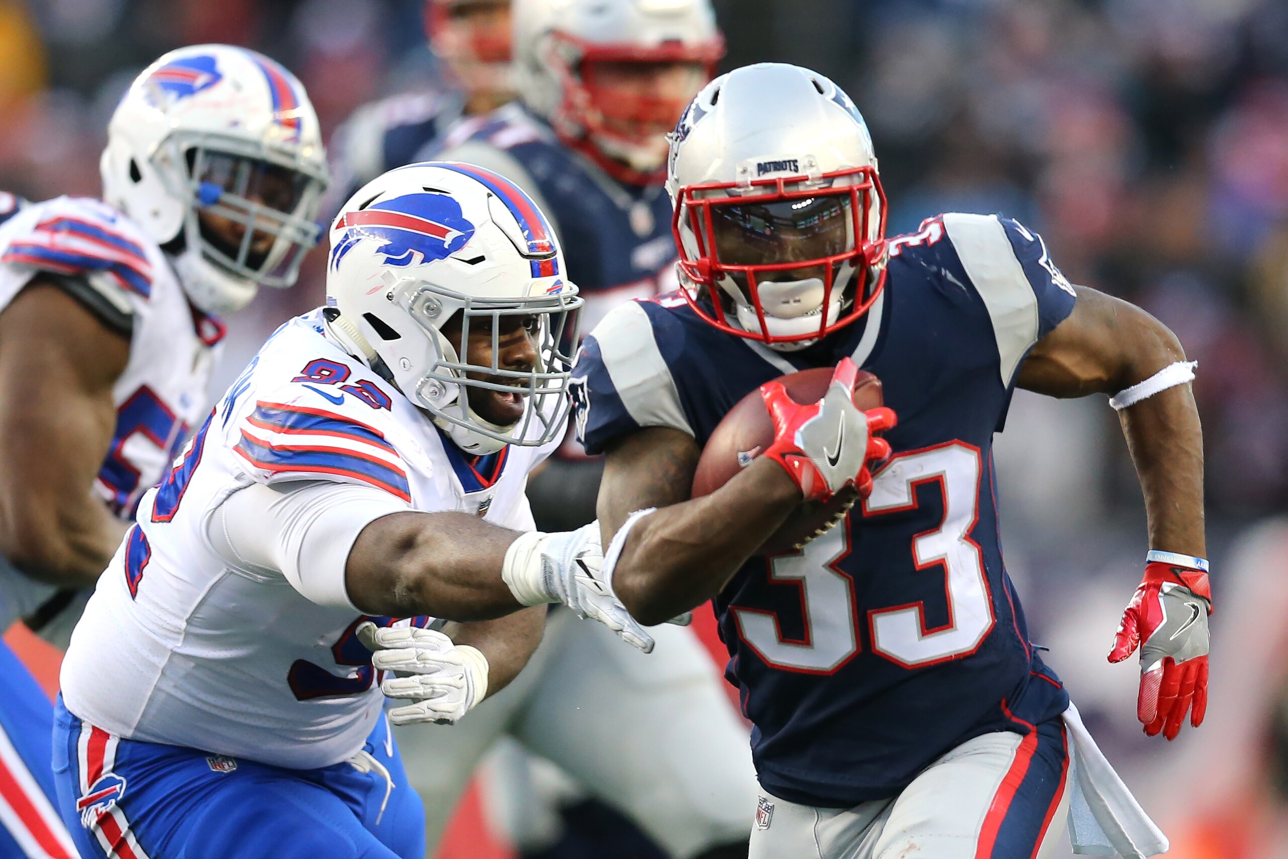 FOXBORO, MA - DECEMBER 24: Dion Lewis #33 of the New England Patriots evades a tackles from LeSean McCoy #25 of the Buffalo Bills during the first half at Gillette Stadium on December 24, 2017 in Foxboro, Massachusetts. (Photo by Maddie Meyer/Getty Images
