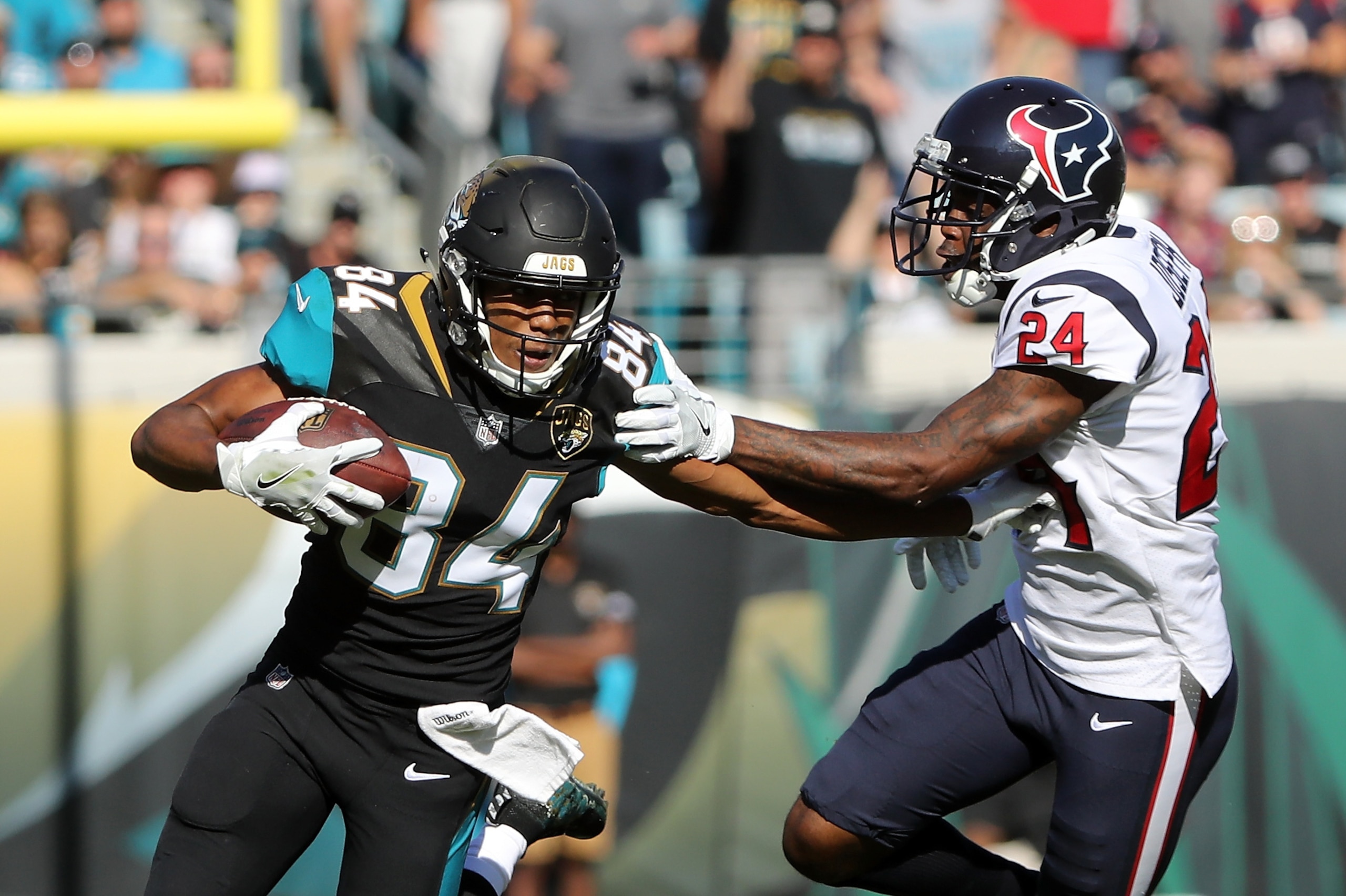 JACKSONVILLE, FL - DECEMBER 17:  Keelan Cole #84 of the Jacksonville Jaguars runs with the football in front of  Johnathan Joseph #24 of the Houston Texans during the first half of their game at EverBank Field on December 17, 2017 in Jacksonville, Florida