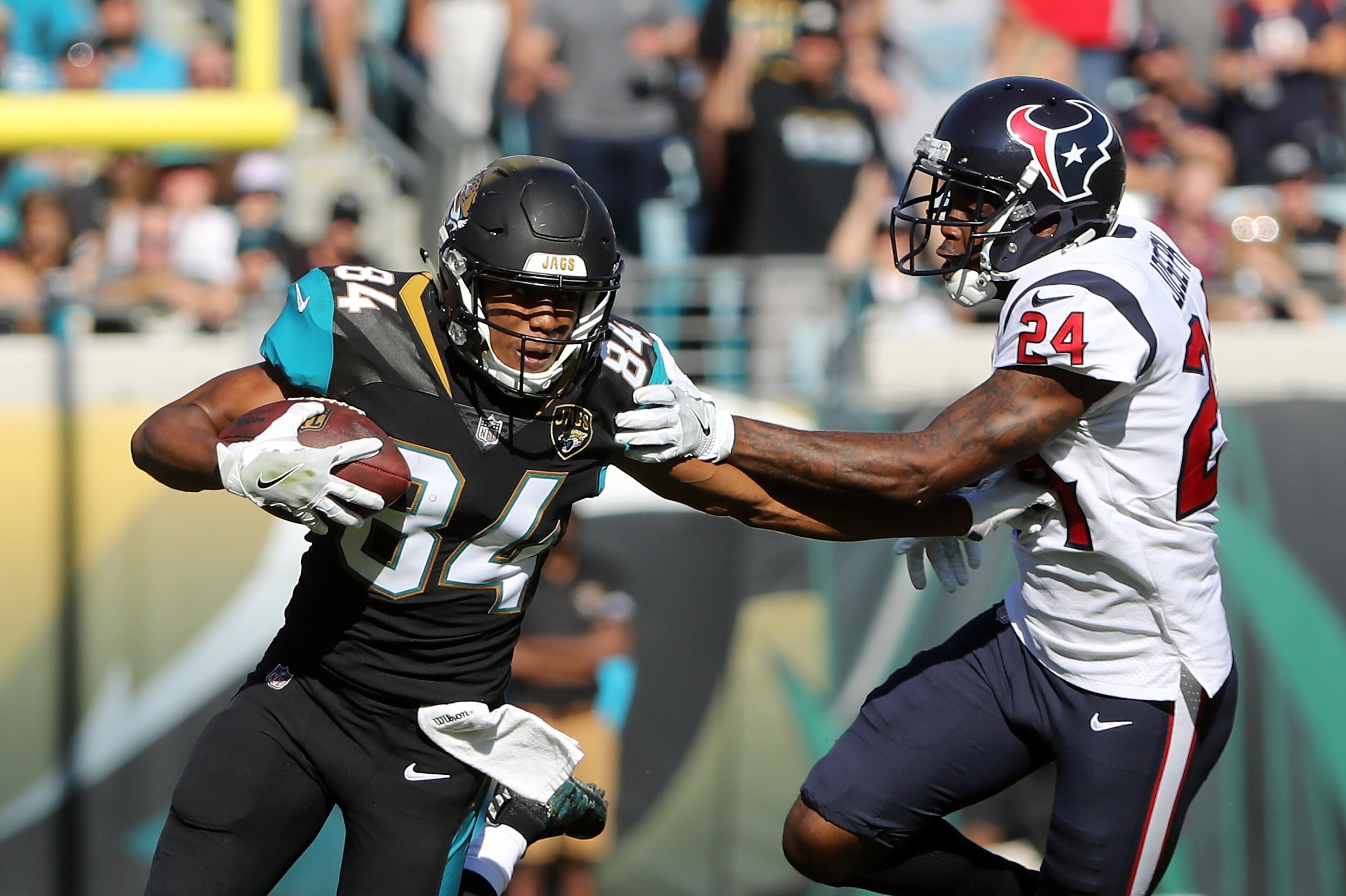 JACKSONVILLE, FL - DECEMBER 17:  Keelan Cole #84 of the Jacksonville Jaguars runs with the football in front of  Johnathan Joseph #24 of the Houston Texans during the first half of their game at EverBank Field on December 17, 2017 in Jacksonville, Florida