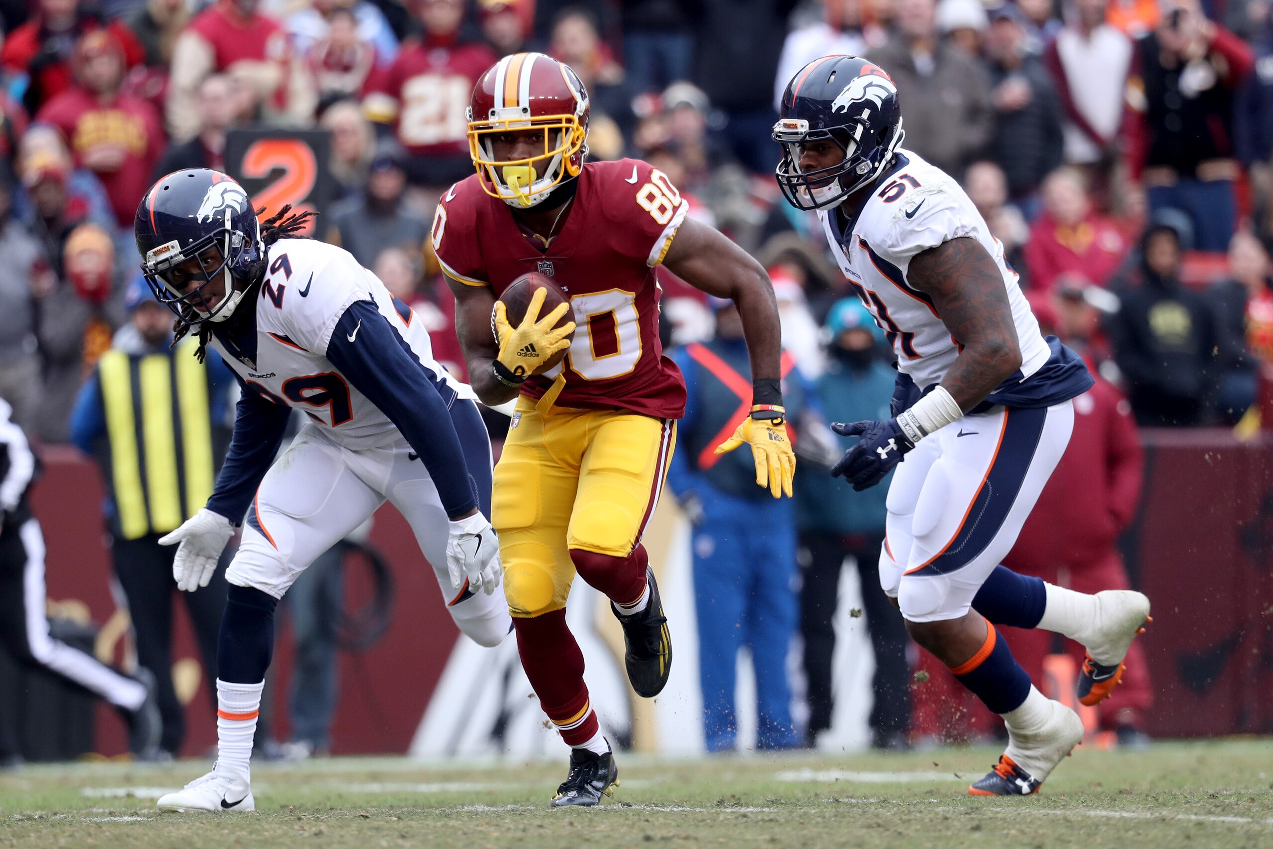 LANDOVER, MD - DECEMBER 24: Wide receiver Jamison Crowder #80 of the Washington Redskins rushes for a touchdown in front of free safety Bradley Roby #29 and inside linebacker Todd Davis #51 of the Denver Broncos after catching a second quarter pass at Fed