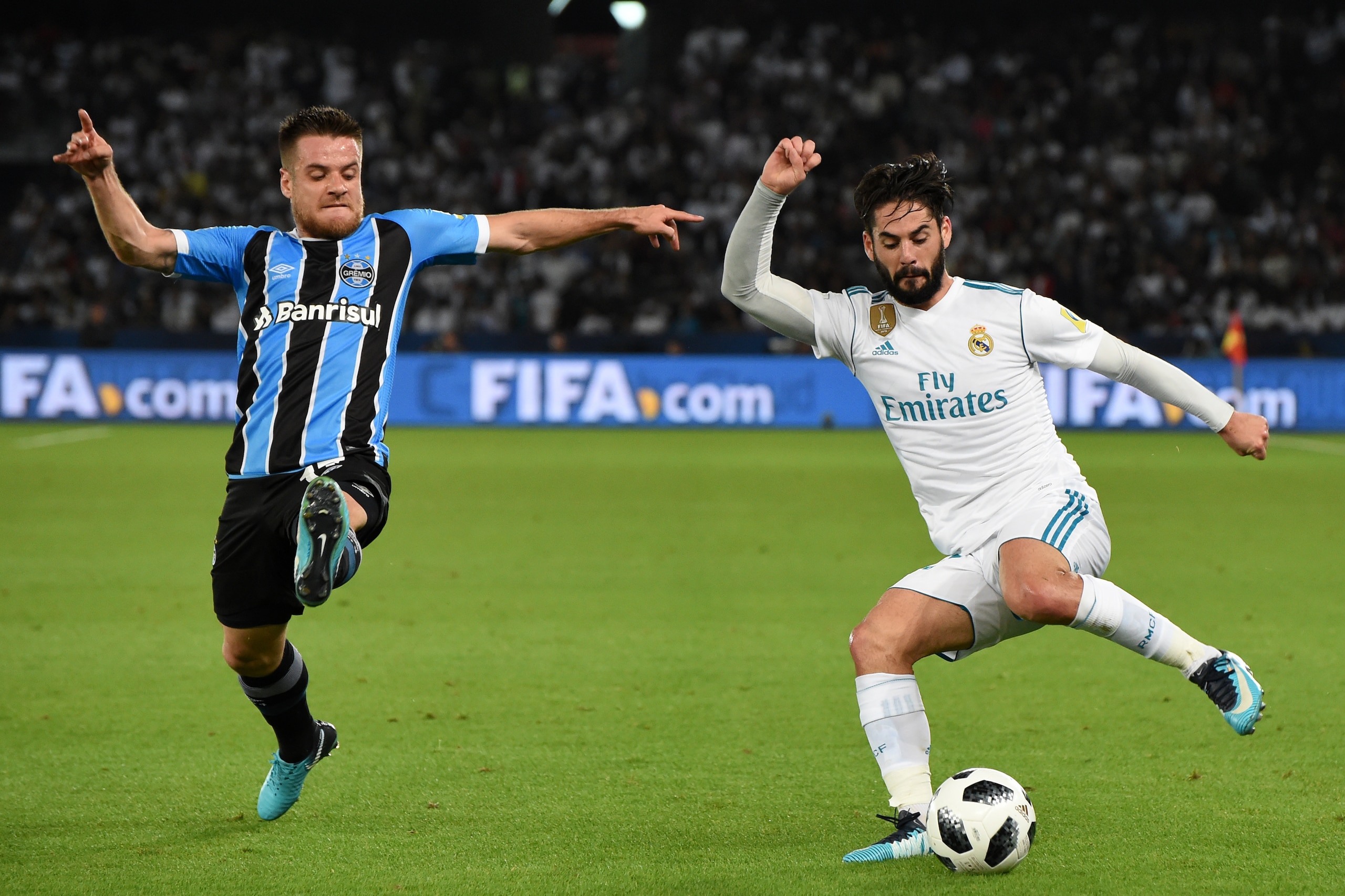 ABU DHABI, UNITED ARAB EMIRATES - DECEMBER 16:  Isco (R) of Real Madrid and Ramiro of Gremio compete for the ball during the FIFA Club World Cup UAE 2017 final match between Gremio and Real Madrid CF at Zayed Sports City Stadium  on December 16, 2017 in A