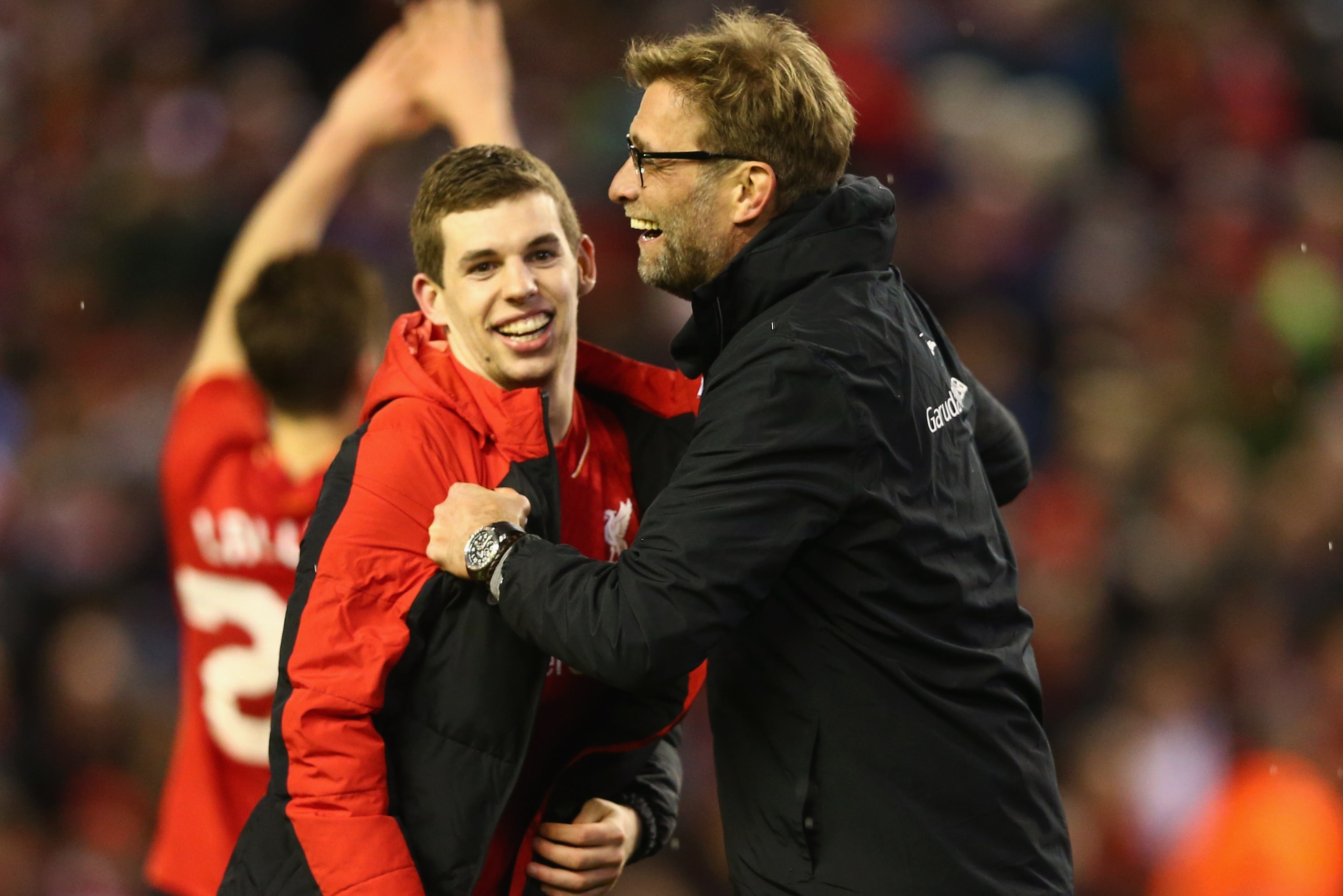 LIVERPOOL, ENGLAND - JANUARY 26:  Jurgen Klopp manager of Liverpool and Jon Flanagan of Liverpool celebrate victory in the penalty shoot out after the Capital One Cup semi final second leg match between Liverpool and Stoke City at Anfield on January 26, 2
